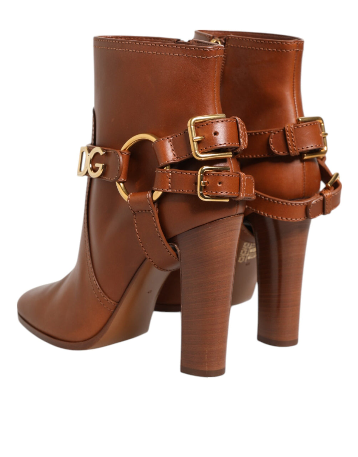 Step into a world of elegance with Dolce & Gabbana's Brown Leather DG Logo Buckle Ankle Boots, crafted from luxurious calf leather for unparalleled sophistication and comfort.