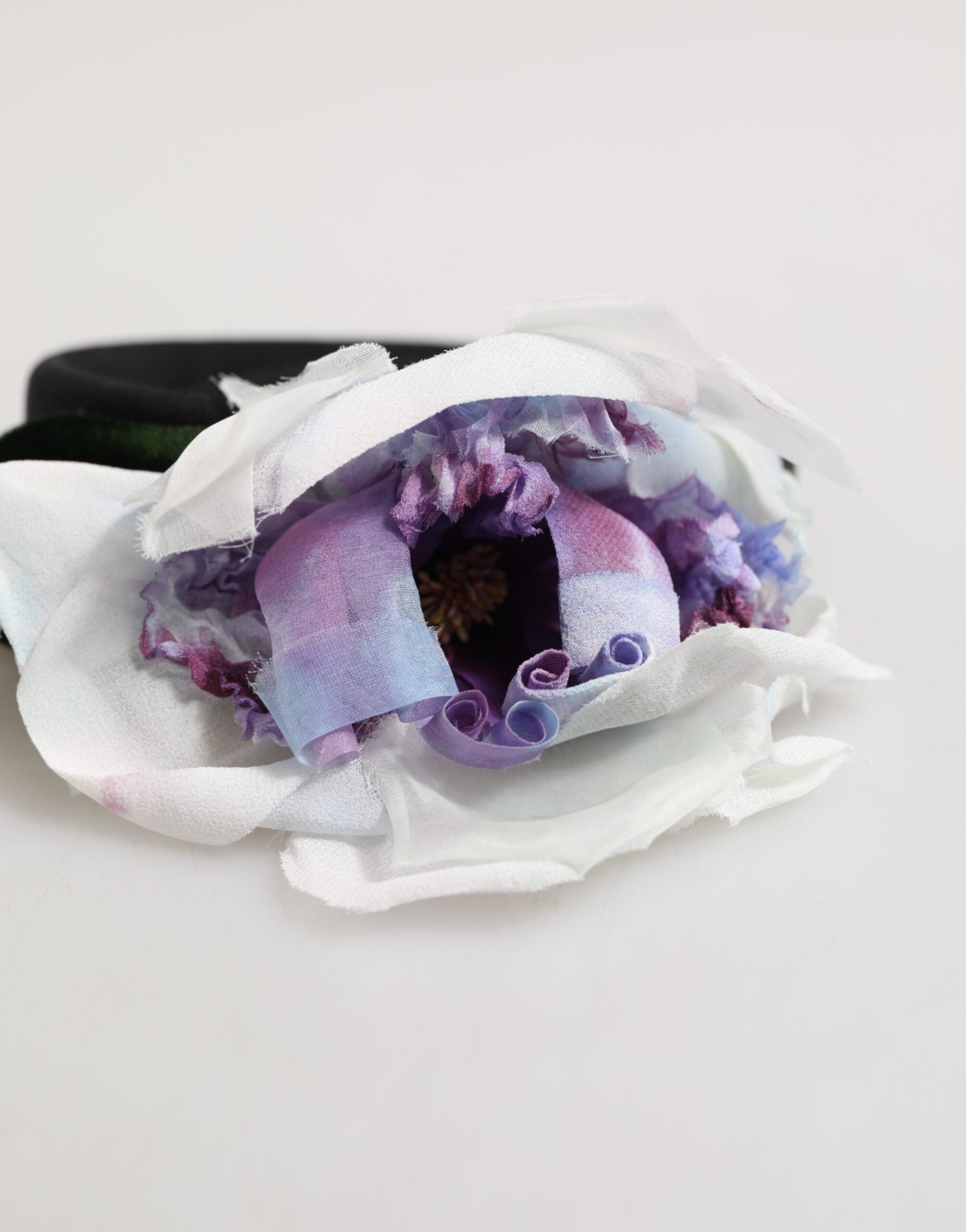 Indulge in the artistry of the Dolce & Gabbana Floral Appliqué Headband, a handcrafted luxury accessory that embodies opulence and timeless elegance for any occasion.