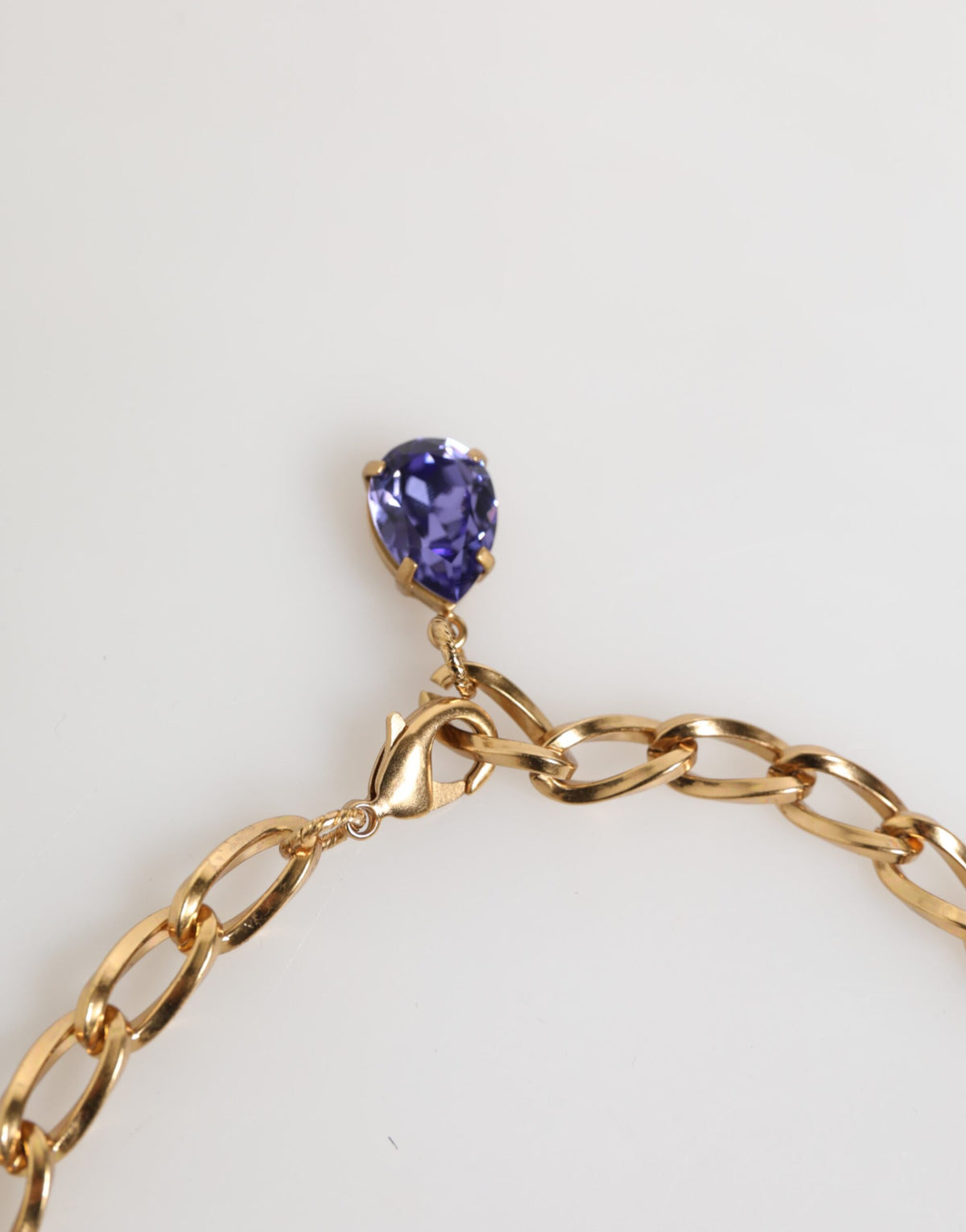 Indulge in the exquisite allure of Dolce & Gabbana's Gold Brass Crystal Pearl Purple Floral Pendant Necklace, a statement of luxury and artistry crafted for the discerning individual.
