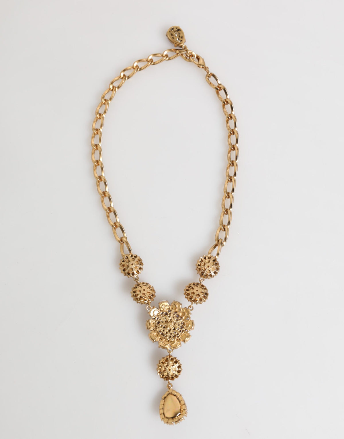 Indulge in the exquisite allure of the Dolce & Gabbana Gold Brass Crystal Pearl Purple Floral Pendant Necklace, a statement of luxury and artistry that elevates any ensemble.