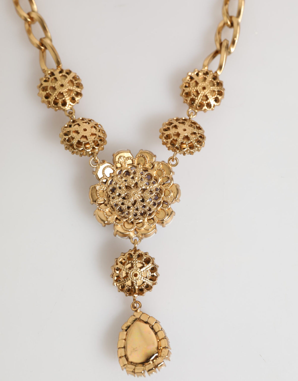 Indulge in the exquisite artistry of the Dolce & Gabbana Gold Brass Crystal Pearl Floral Pendant Necklace, a luxurious statement piece that embodies elegance and allure.