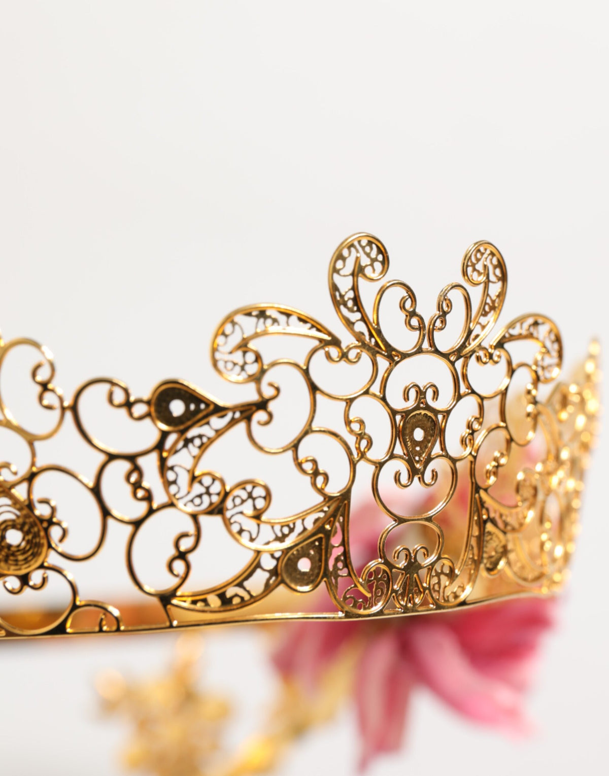 Elevate your elegance with the Dolce & Gabbana Gold Floral Tiara, a stunning crown headband of gold-tone brass, soft fabric flowers, and shimmering crystals, perfect for unforgettable moments.