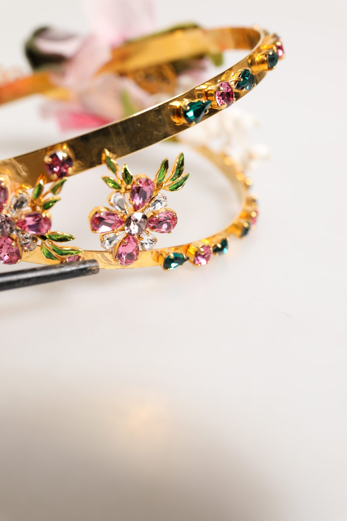 Elevate your elegance with the Dolce & Gabbana Gold Floral Tiara, a masterpiece of opulent craftsmanship adorned with delicate flowers and shimmering crystals, perfect for any sophisticated occasion.