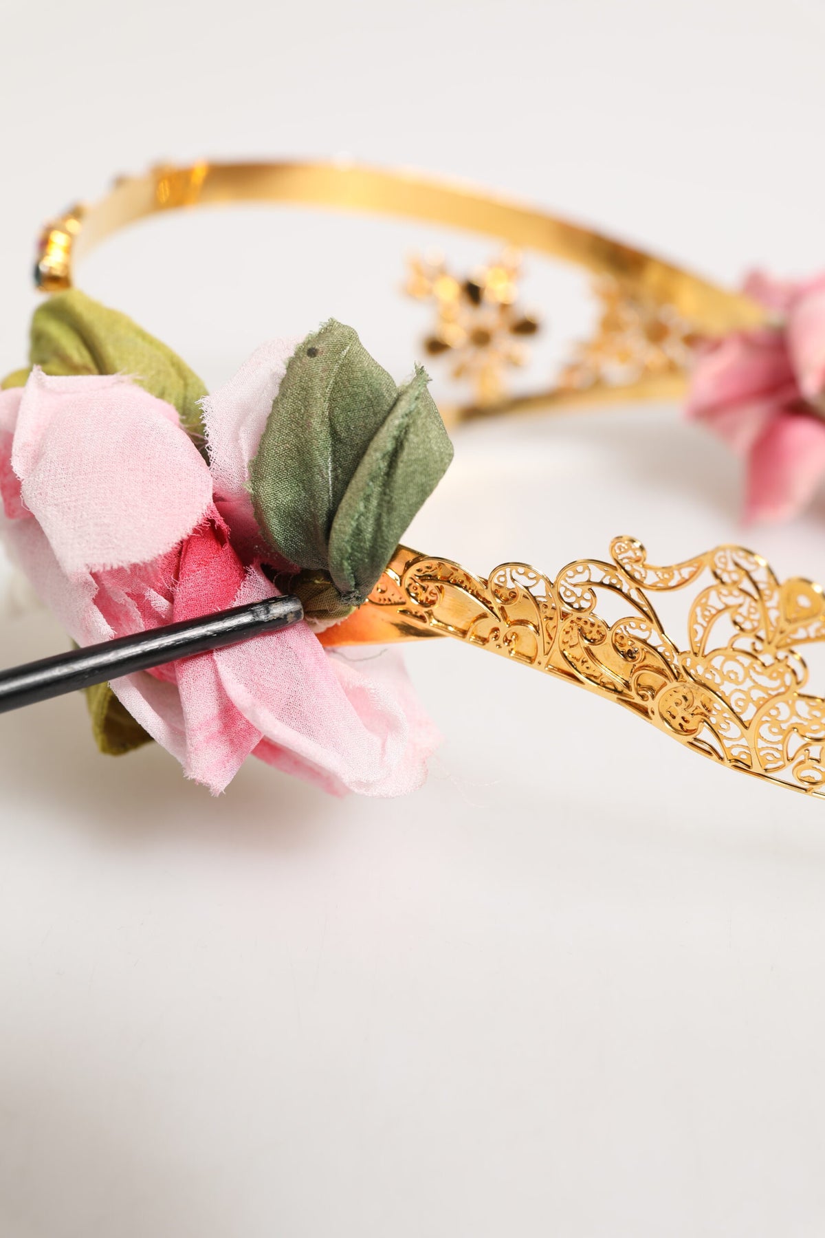 Elevate your elegance with the Dolce & Gabbana Gold Floral Tiara, a masterpiece of haute couture adorned with delicate roses and shimmering crystals, embodying timeless sophistication.