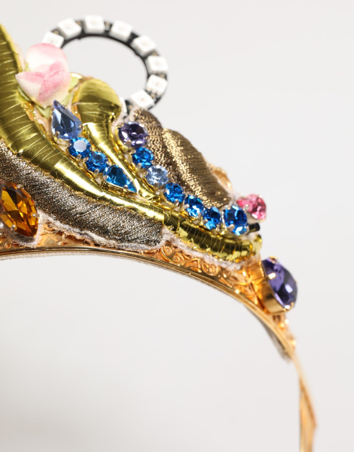 Indulge in the opulence of the Dolce & Gabbana Gold Brass Crystal Embellished Crown Tiara, a luxurious statement piece that elevates your elegance and allure.