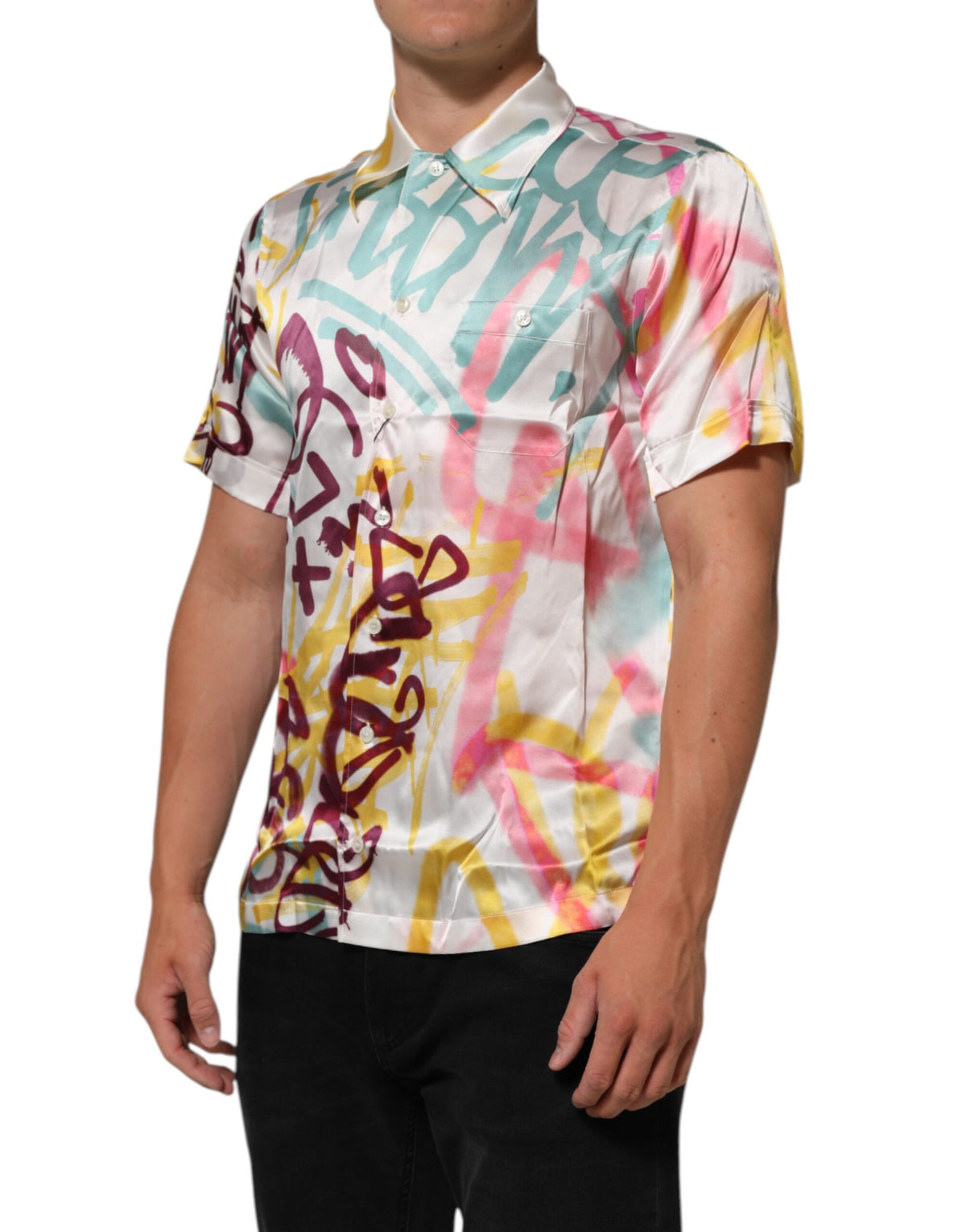 Indulge in the exquisite Dolce & Gabbana White Silk Hawaiian Graffiti Print Shirt, where luxurious silk meets vibrant artistry, perfect for summer sophistication and effortless elegance.