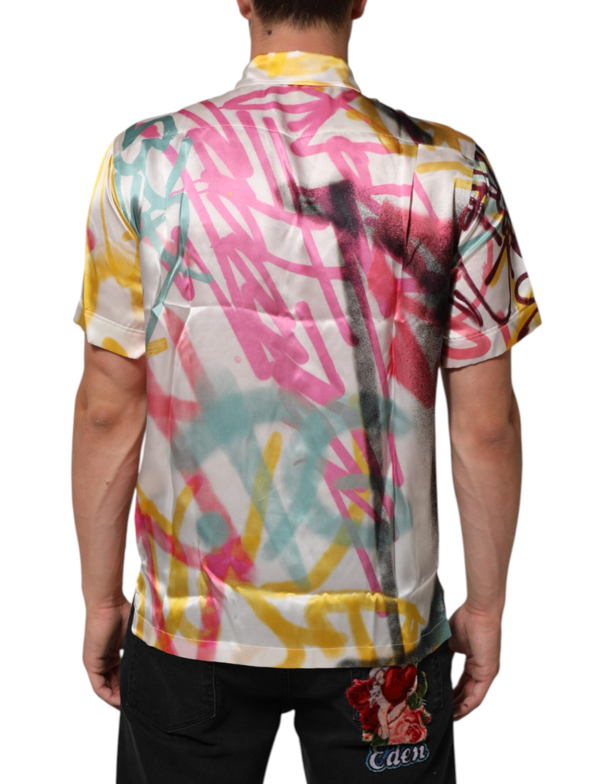 Indulge in the exquisite Dolce & Gabbana White Silk Hawaiian Graffiti Print Shirt, a masterpiece of artistry and elegance that elevates your summer sophistication.
