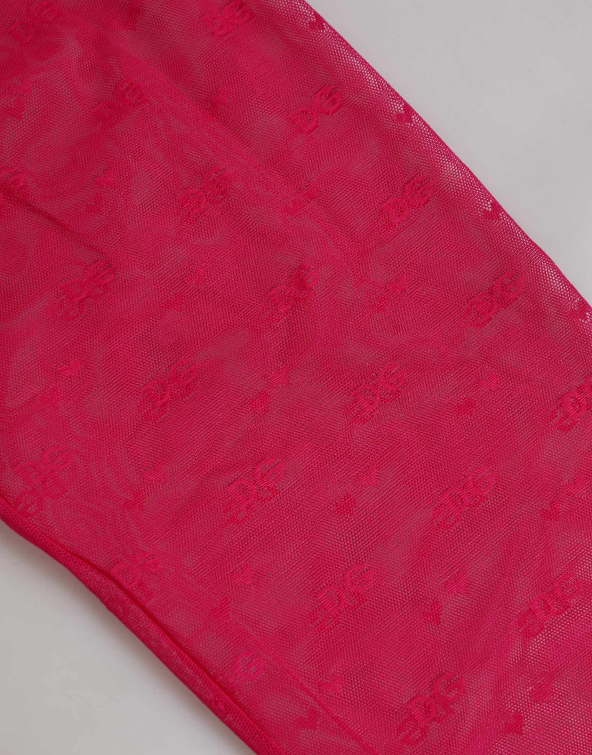 Discover the allure of Dolce & Gabbana's Fuchsia Nylon Logo Lace Leggings, a luxurious blend of comfort and elegance, crafted for the discerning individual.