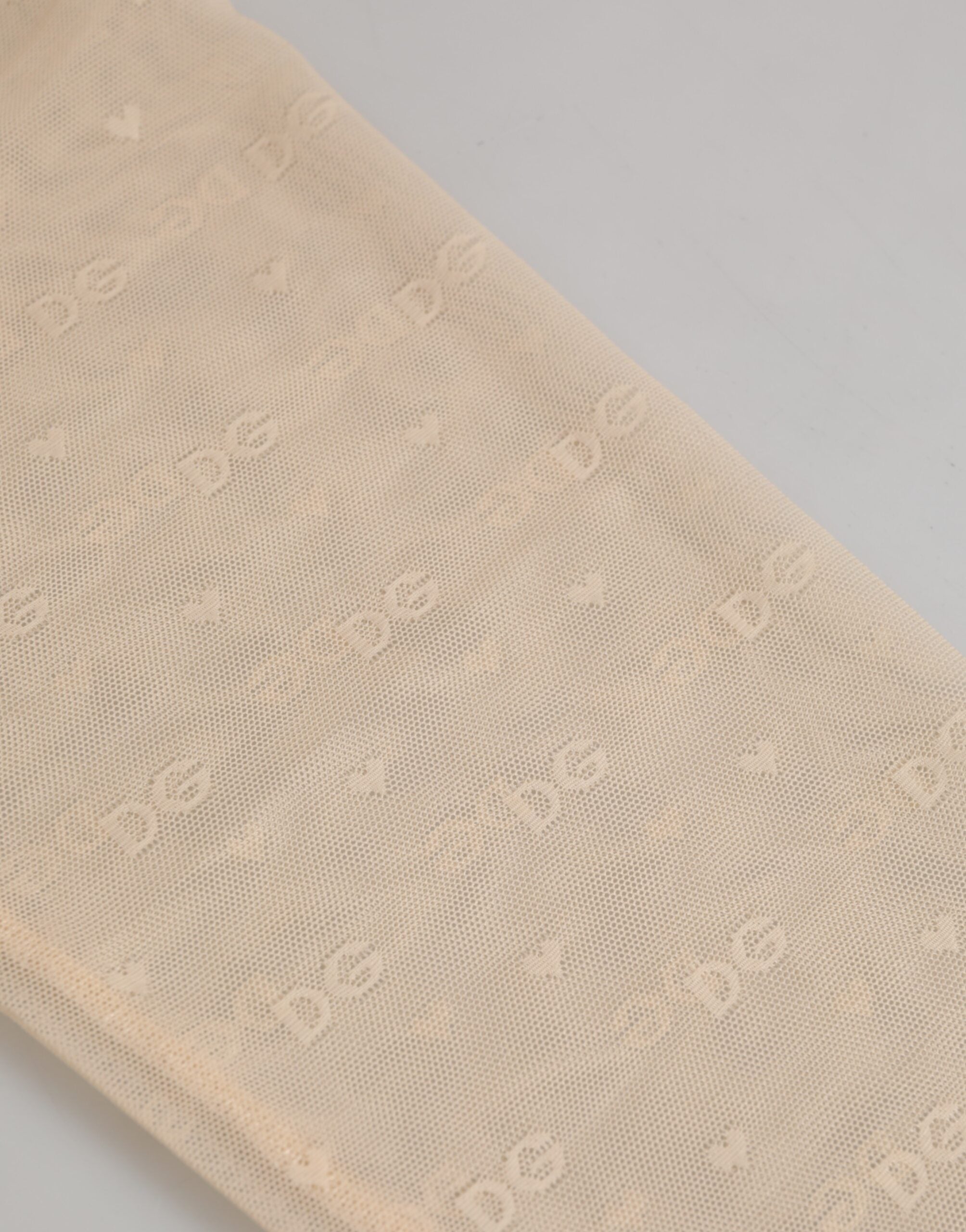 Indulge in the exquisite Dolce & Gabbana Beige Nylon Logo Lace Leggings, where luxurious craftsmanship meets sensual elegance, perfect for the discerning individual.