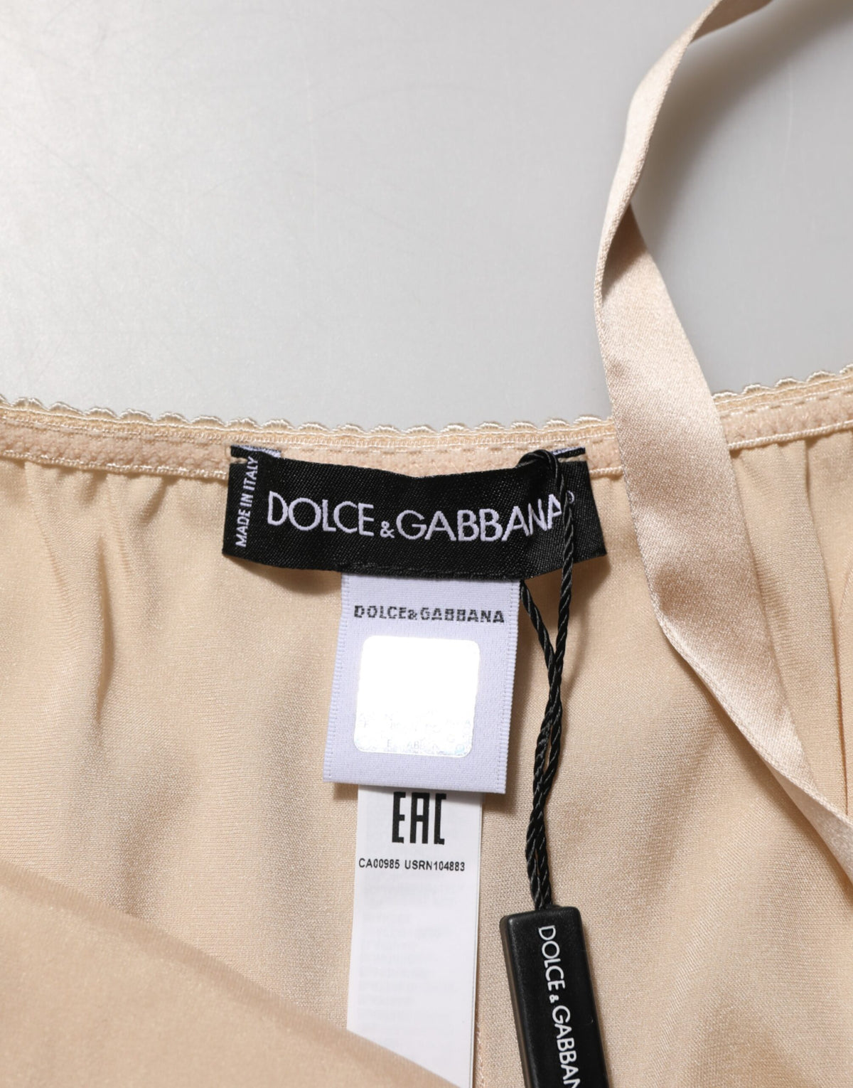 Indulge in the exquisite Dolce & Gabbana Nude Chemise, a silk blend masterpiece with lace trim, embodying sensual elegance and timeless allure for the discerning individual.