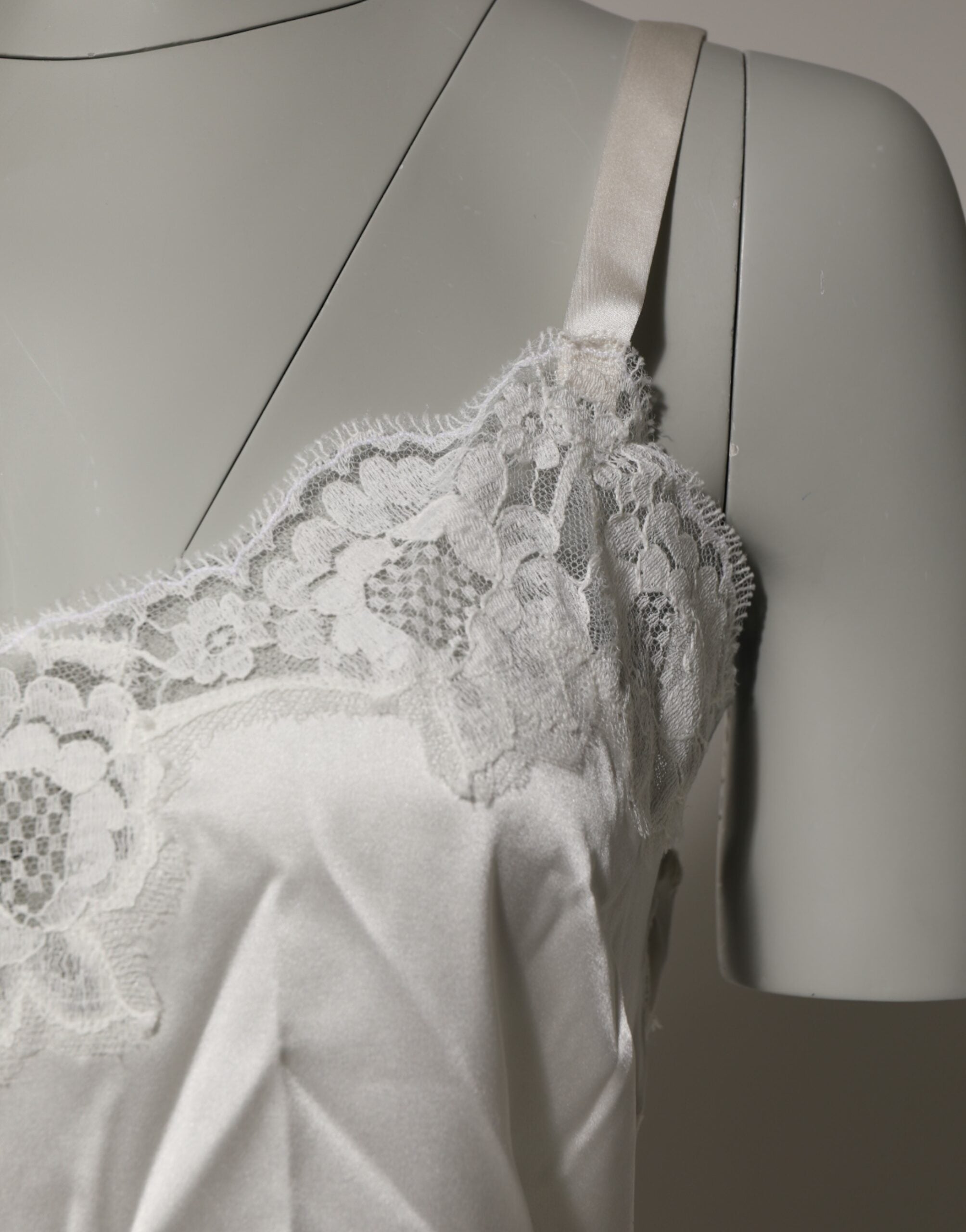 Indulge in the exquisite Dolce & Gabbana Off White Floral Lace Tank, a luxurious blend of silk and lace that redefines elegance and sophistication for every occasion.