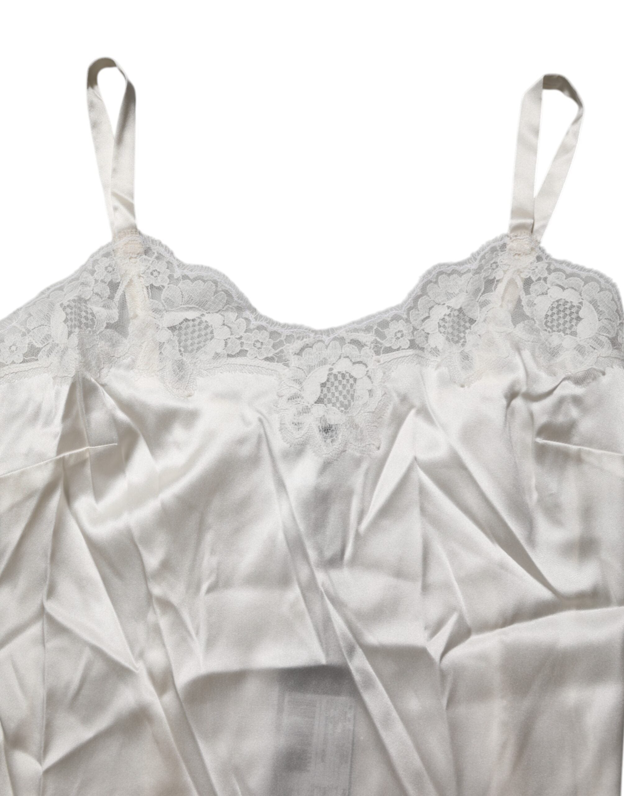 Indulge in the exquisite Dolce & Gabbana Off White Floral Lace Tank, a luxurious blend of silk and lace that redefines elegance and sensuality for the discerning individual.