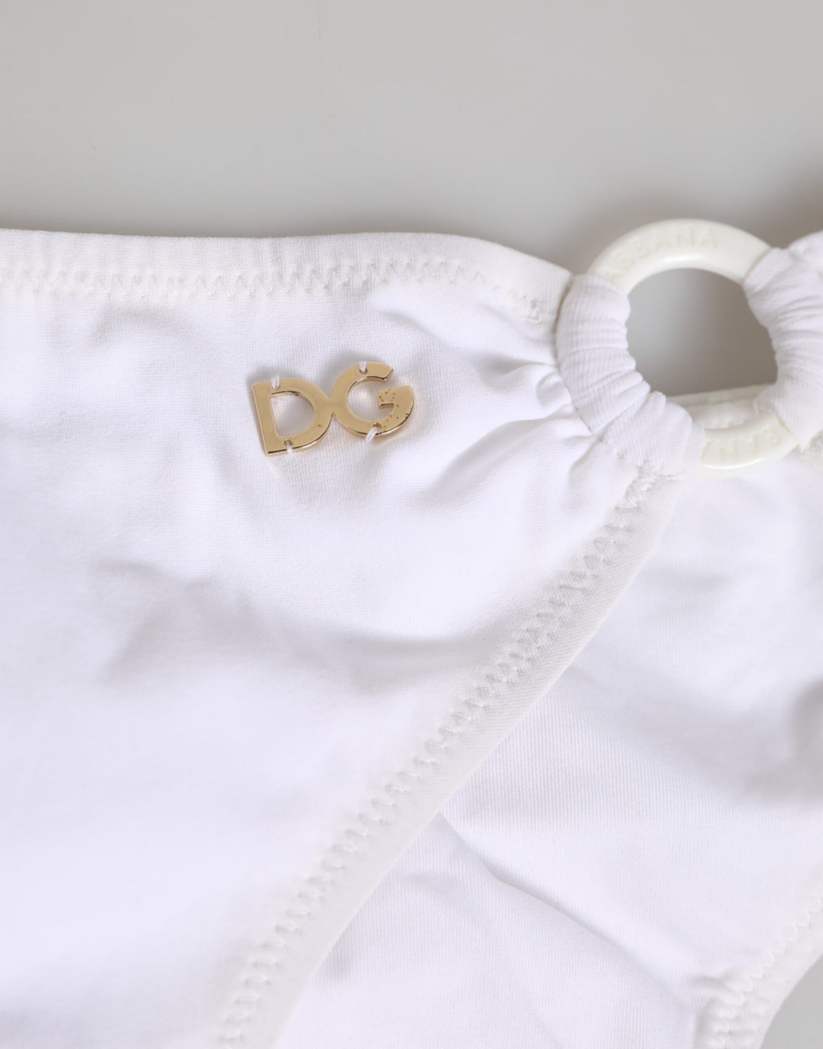 Indulge in the Dolce & Gabbana White Logo Swimsuit, a masterpiece of Italian craftsmanship, blending luxury and elegance for the discerning individual who embraces sophistication.