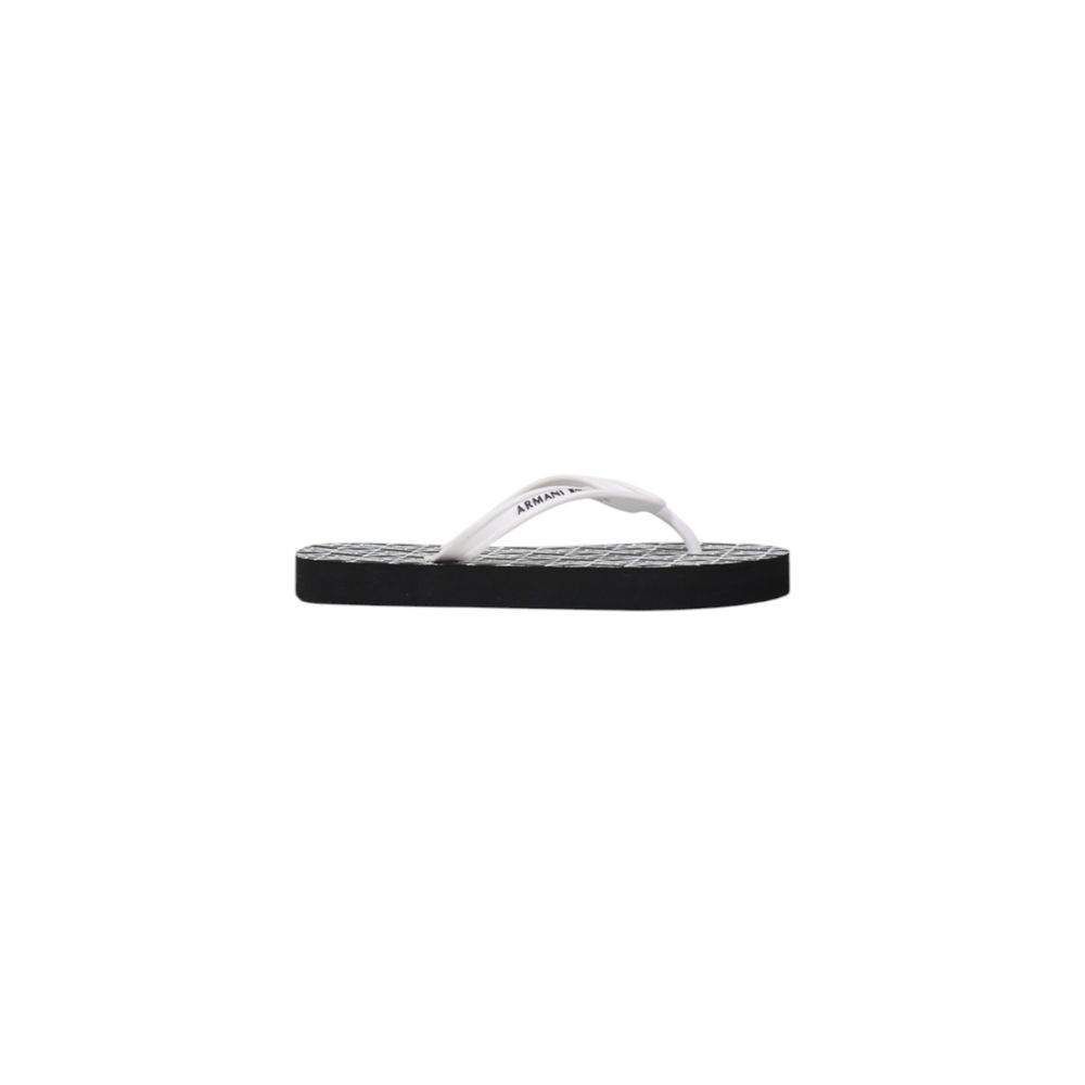 Elevate your summer elegance with Armani Exchange Black And White Rubber Flip-Flop Sandals, crafted from luxurious rubber for unmatched comfort and sophistication.