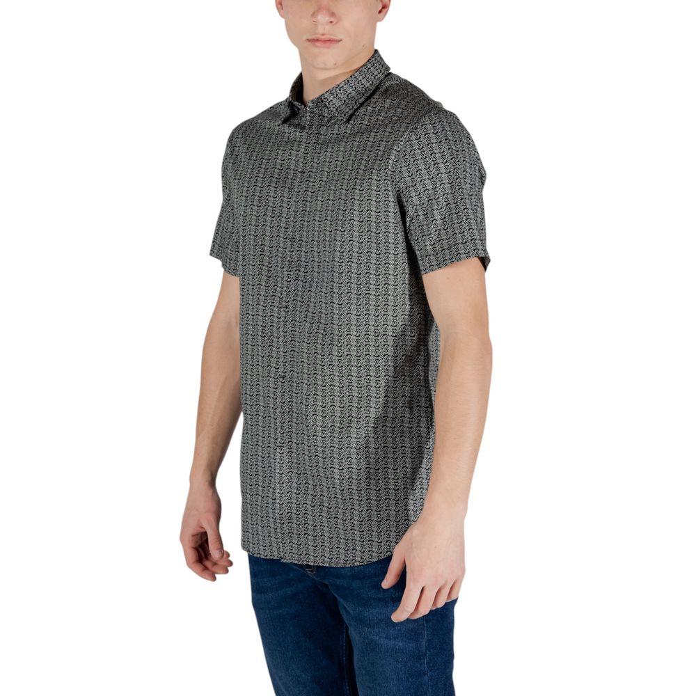 Elevate your wardrobe with the Armani Exchange Black Cotton Shortsleeve Shirt, a seamless blend of luxury and comfort, perfect for the discerning individual.