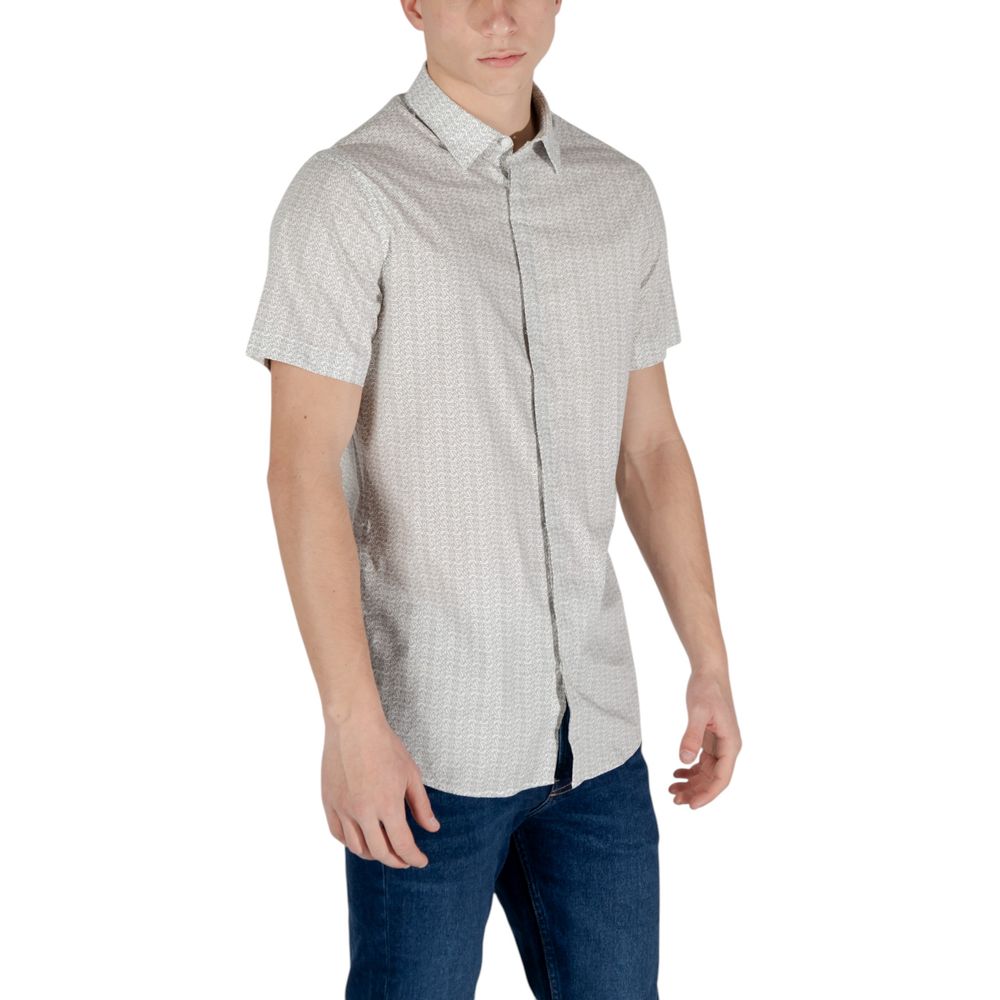 Elevate your wardrobe with the Armani Exchange Cream Cotton Shortsleeve Shirt, a luxurious blend of comfort and sophistication, perfect for any occasion.