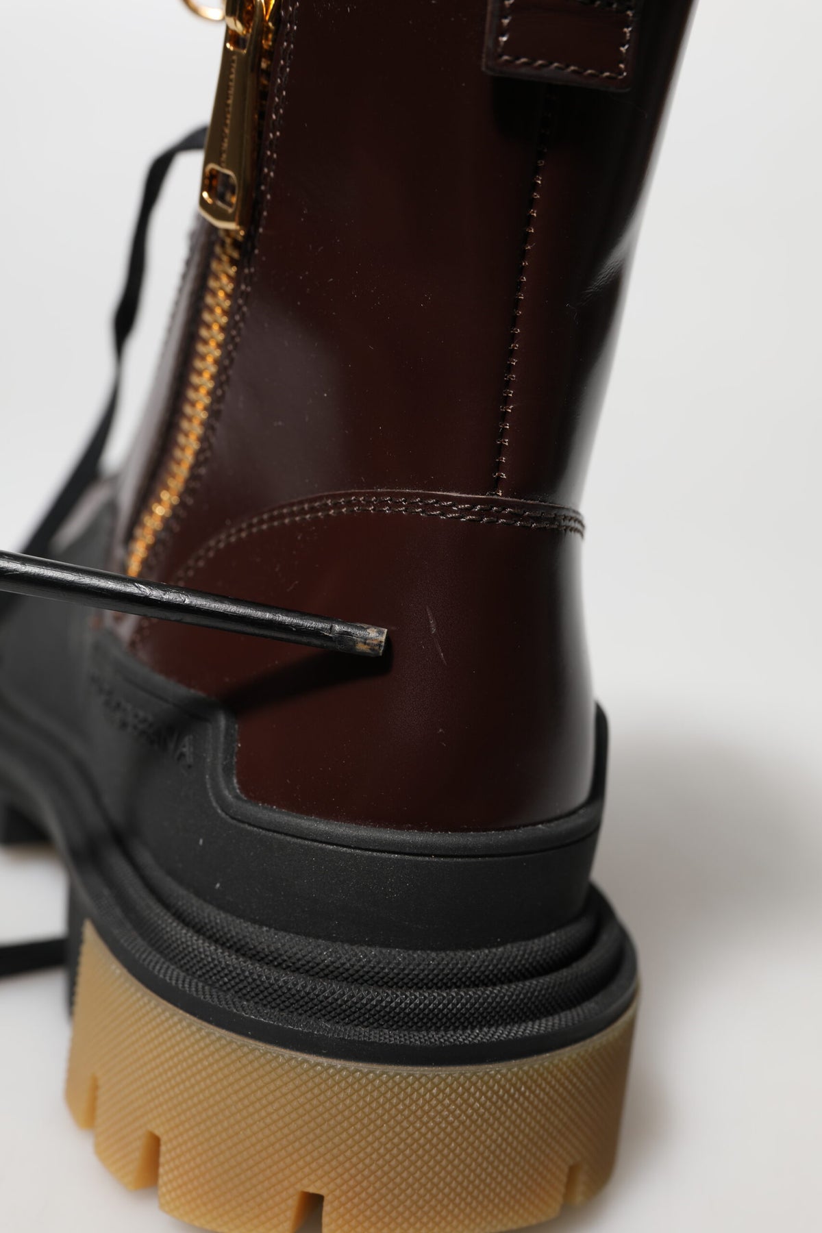 Experience the allure of Dolce & Gabbana's Maroon Leather Mid Calf Biker Boots, crafted in Italy from exquisite calf leather, blending luxury with timeless elegance.