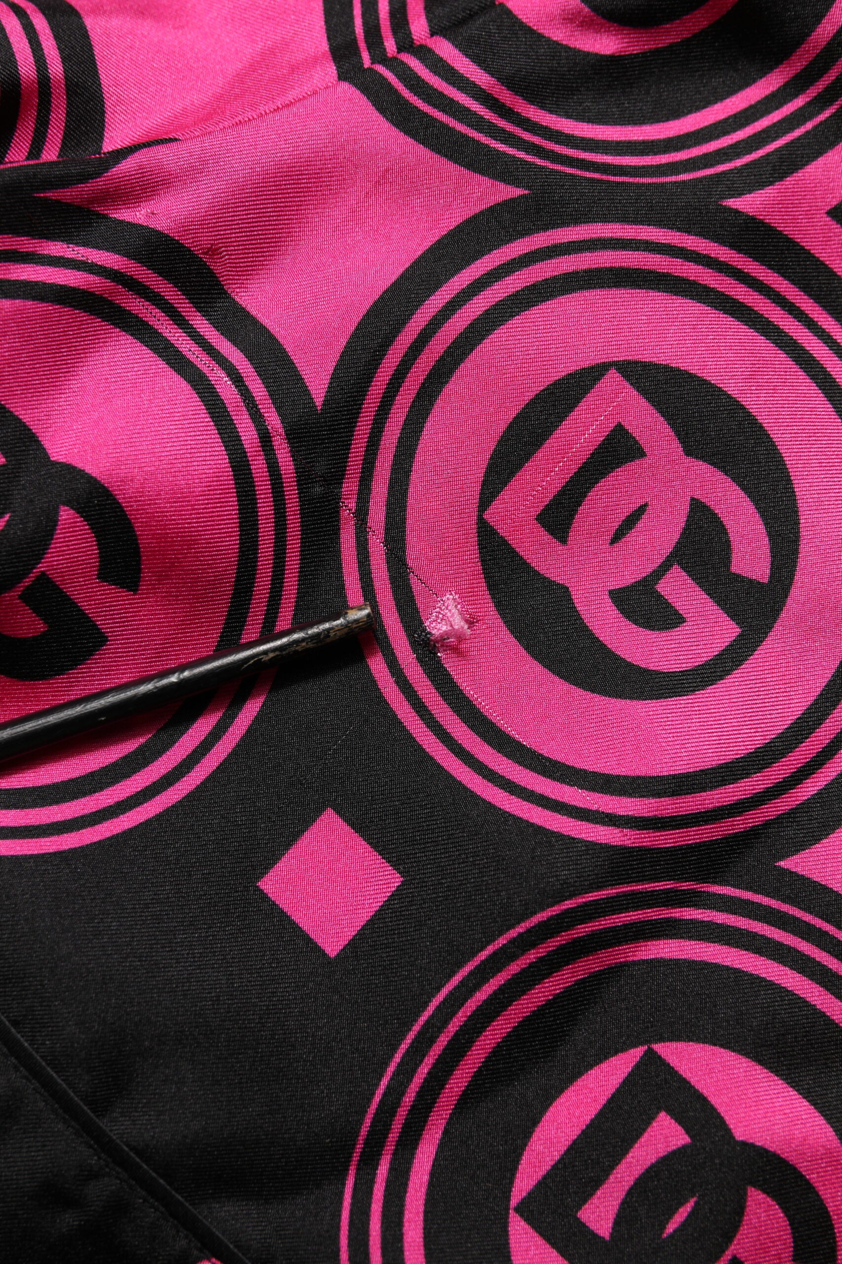 Elevate your wardrobe with Dolce & Gabbana's Pink Black Silk Logo Print DG Pattern Shorts, a testament to Italian craftsmanship and luxurious elegance for the discerning fashion connoisseur.