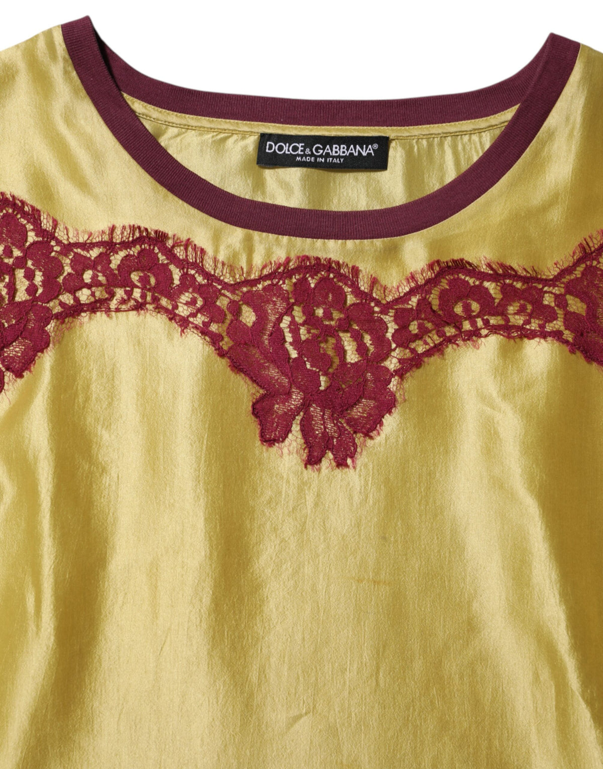 Indulge in the exquisite allure of Dolce & Gabbana's Yellow Silk Satin Floral Lace Top, a masterpiece of Italian craftsmanship that embodies timeless elegance and modern femininity.