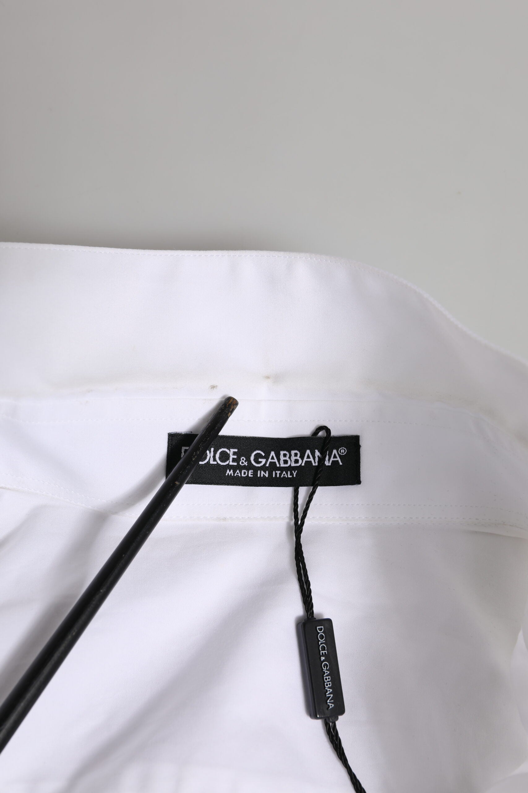 Elevate your wardrobe with the Dolce & Gabbana White Crystal Embellished Dress Shirt, a masterpiece of Italian craftsmanship in premium cotton, designed for timeless elegance.