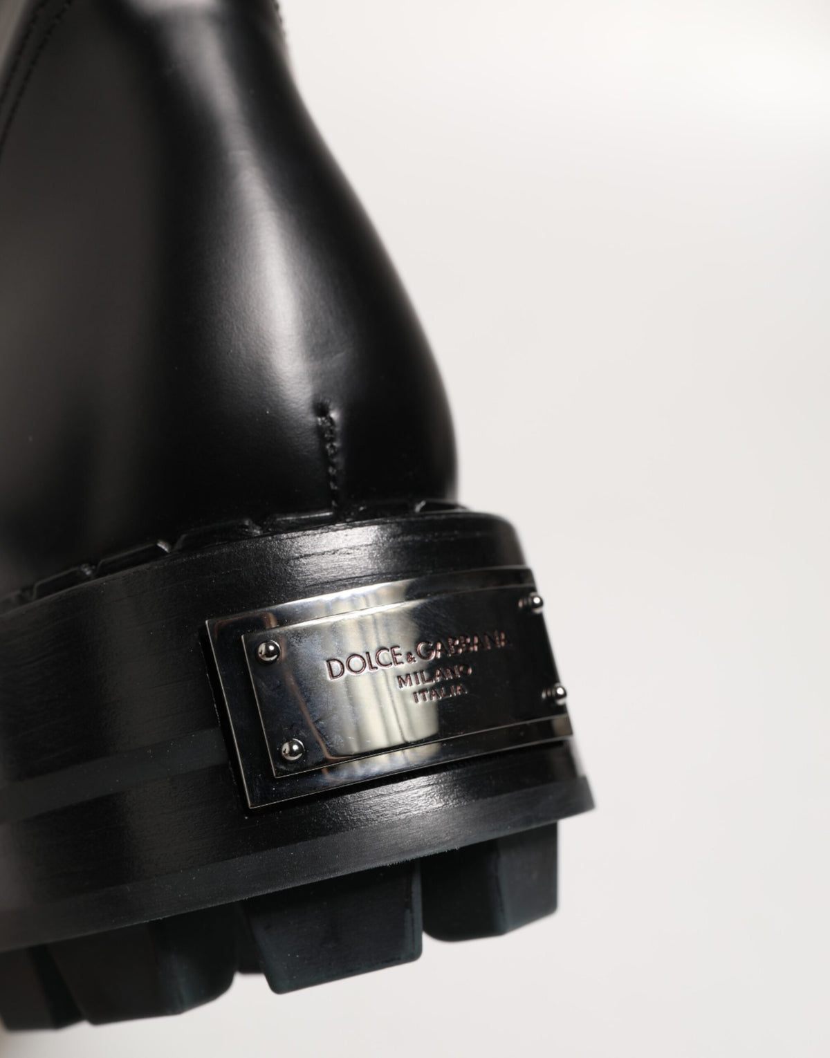 Step into elegance with Dolce & Gabbana's Black Logo Plaque Mid Calf Biker Boots, crafted from premium leather in Italy, merging timeless style with unmatched comfort.