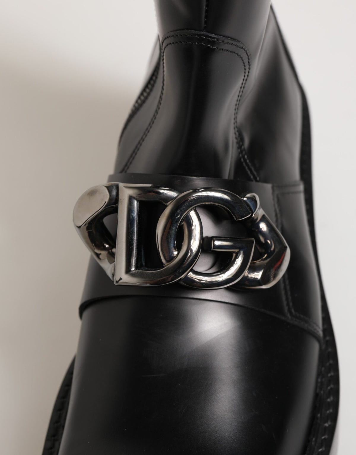 Elevate your style with Dolce & Gabbana Black Logo Plaque Mid Calf Biker Boots, crafted from premium black calf leather for timeless sophistication and effortless allure.