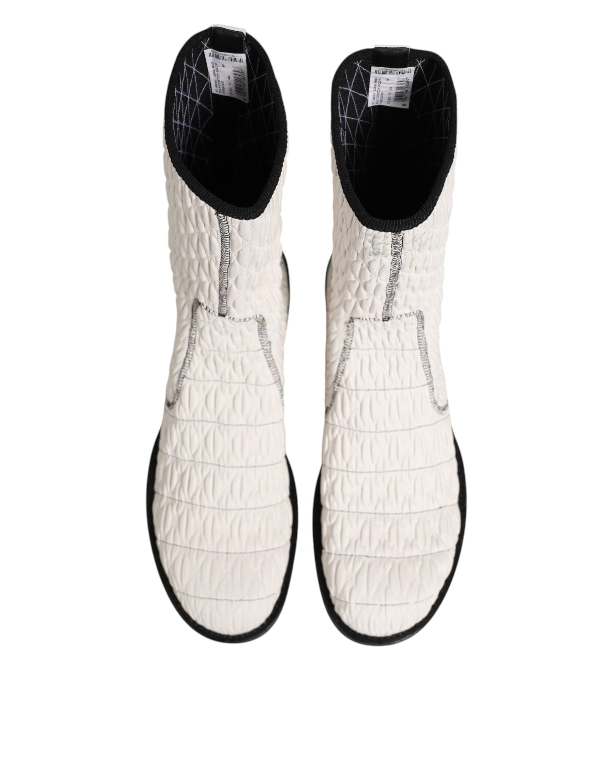 Experience the allure of Dolce & Gabbana's White Lambskin Leather Mid Calf Boots, where exquisite craftsmanship meets modern elegance for the discerning fashionista.