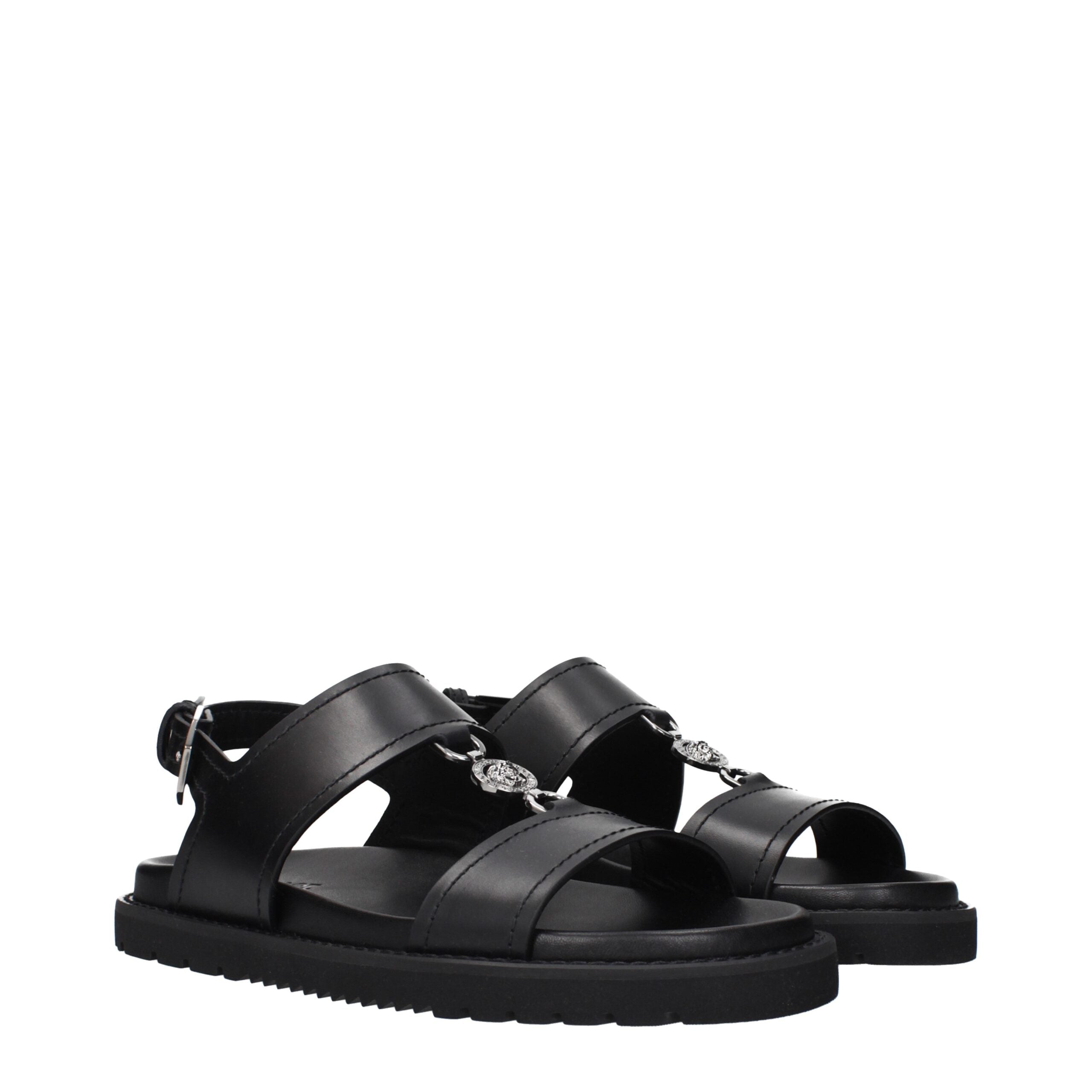 Experience the allure of Versace Black Leather Flat Sandals, where exquisite craftsmanship meets timeless elegance, perfect for those who embody sophistication and grace.