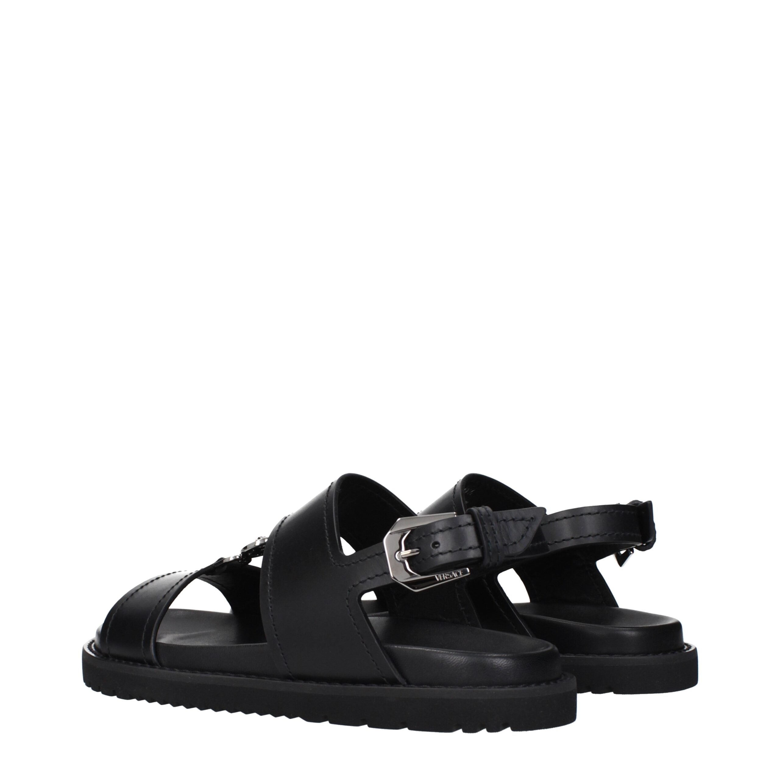 Step into elegance with Versace Black Leather Flat Sandals, where premium craftsmanship meets timeless allure, perfect for the discerning individual seeking luxurious sophistication.
