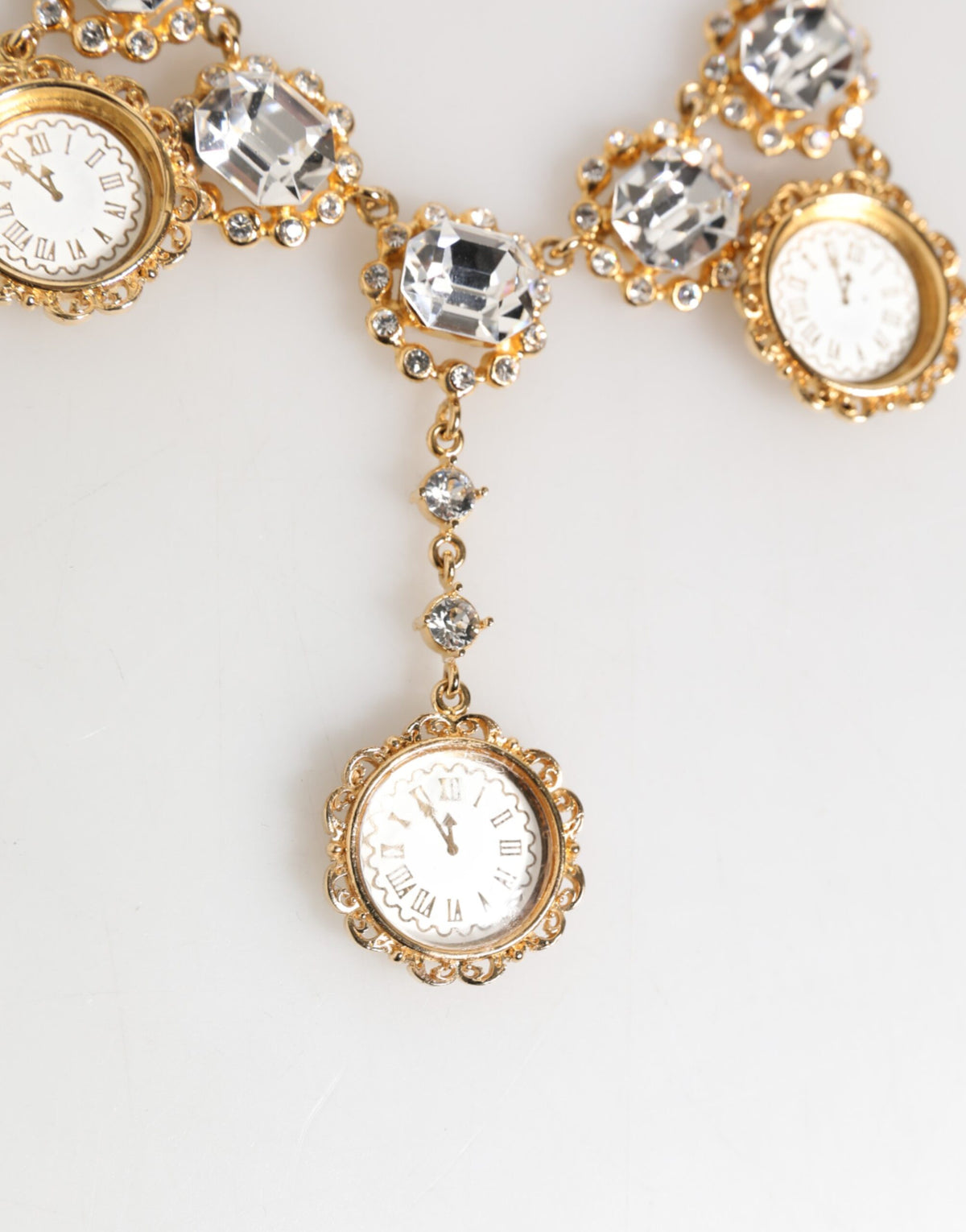 Indulge in the exquisite Dolce & Gabbana Gold Crystal Clock Pendant Necklace, a luxurious blend of crystal and brass that embodies timeless sophistication and elegance.