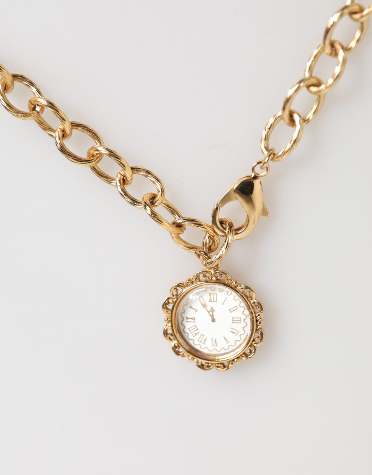 Indulge in the exquisite Dolce & Gabbana Gold Crystal Clock Pendant Necklace, a timeless blend of crystal and brass, embodying luxury and sophistication for the discerning individual.