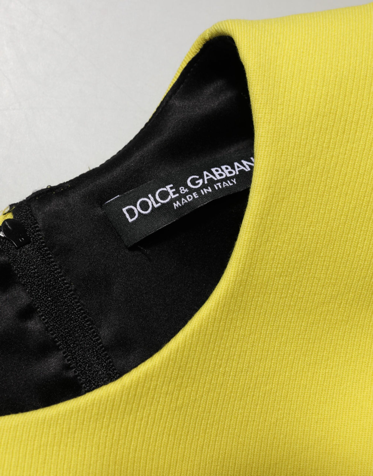 Indulge in the exquisite Dolce & Gabbana Yellow A-line Sheath Mini Dress, a luxurious blend of silk and wool, crafted in Italy for those who embody elegance and sophistication.