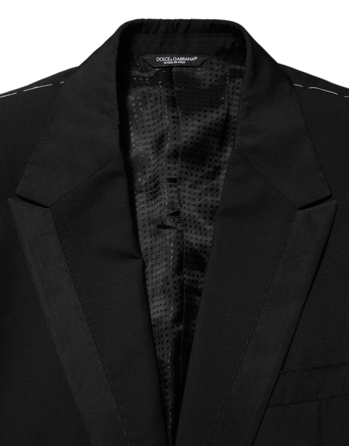 Elevate your wardrobe with the Dolce & Gabbana Black Wool Blazer, a masterpiece of Italian craftsmanship, blending luxurious materials for timeless sophistication.