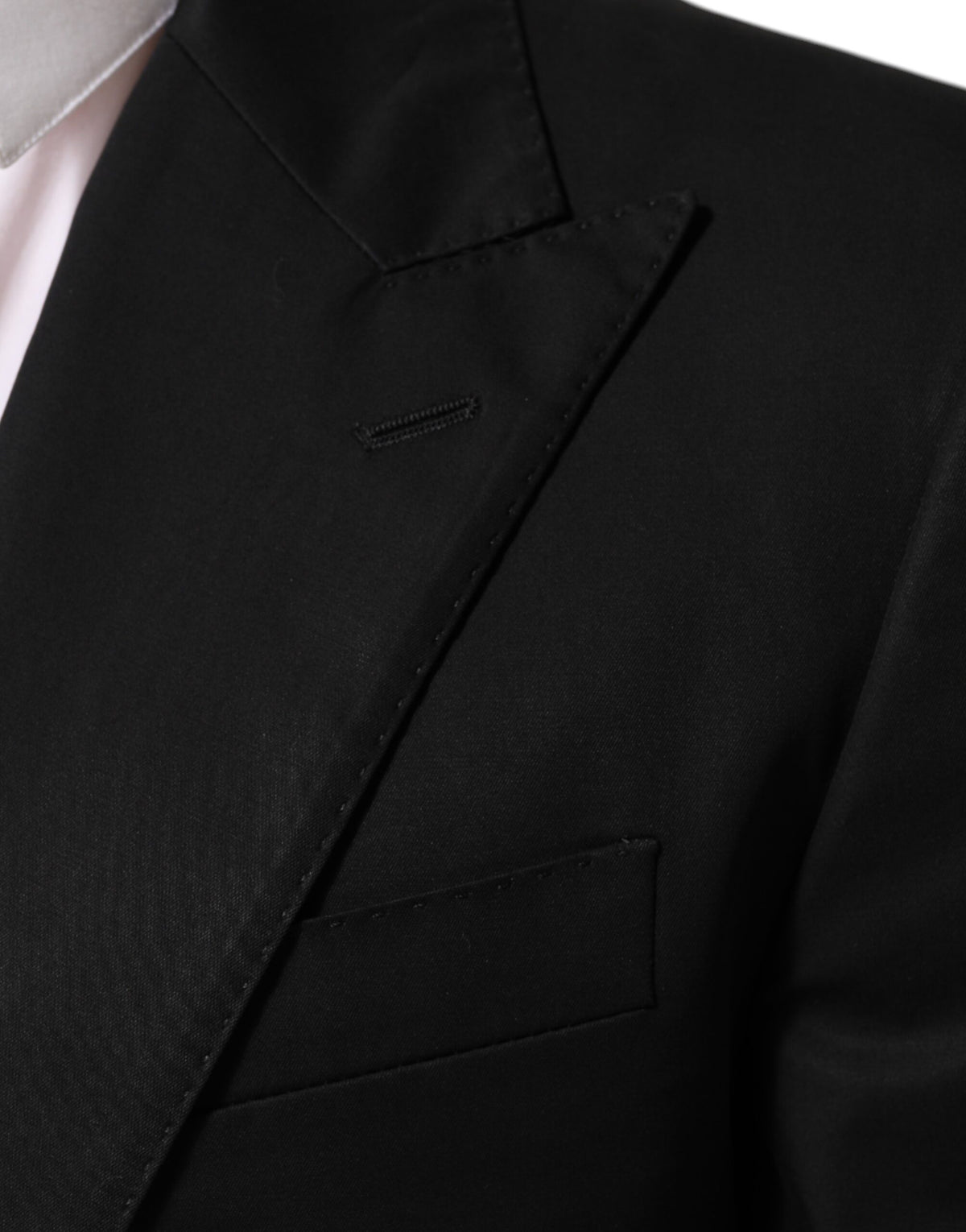 Elevate your wardrobe with the Dolce & Gabbana Black Wool 2 Buttons Suit Men Jacket Blazer, a masterpiece of Italian craftsmanship that embodies timeless elegance and sophistication.