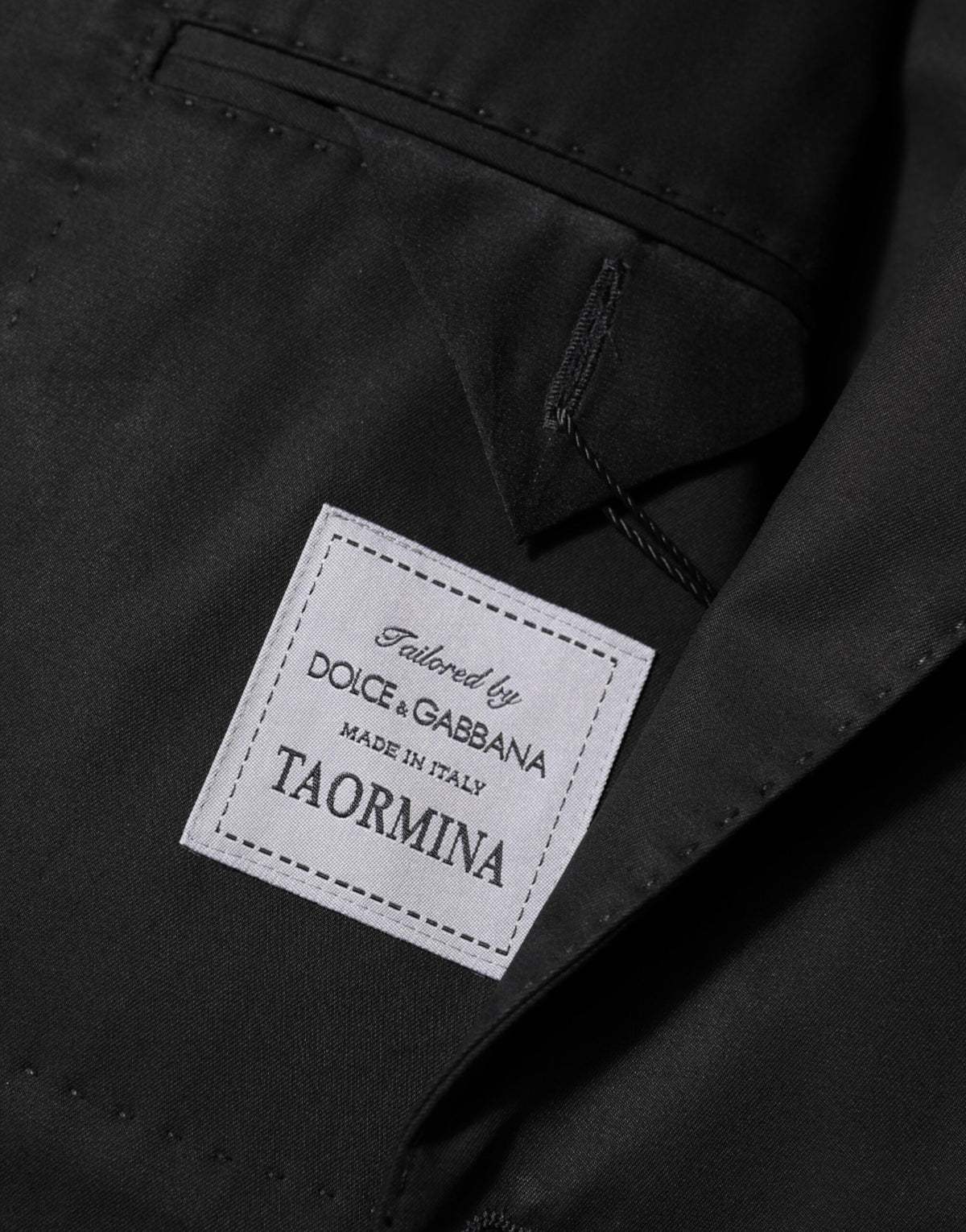 Elevate your style with the Dolce & Gabbana Black Wool 2 Buttons Suit Men Jacket Blazer, a masterpiece of Italian craftsmanship that embodies timeless elegance and sophistication.