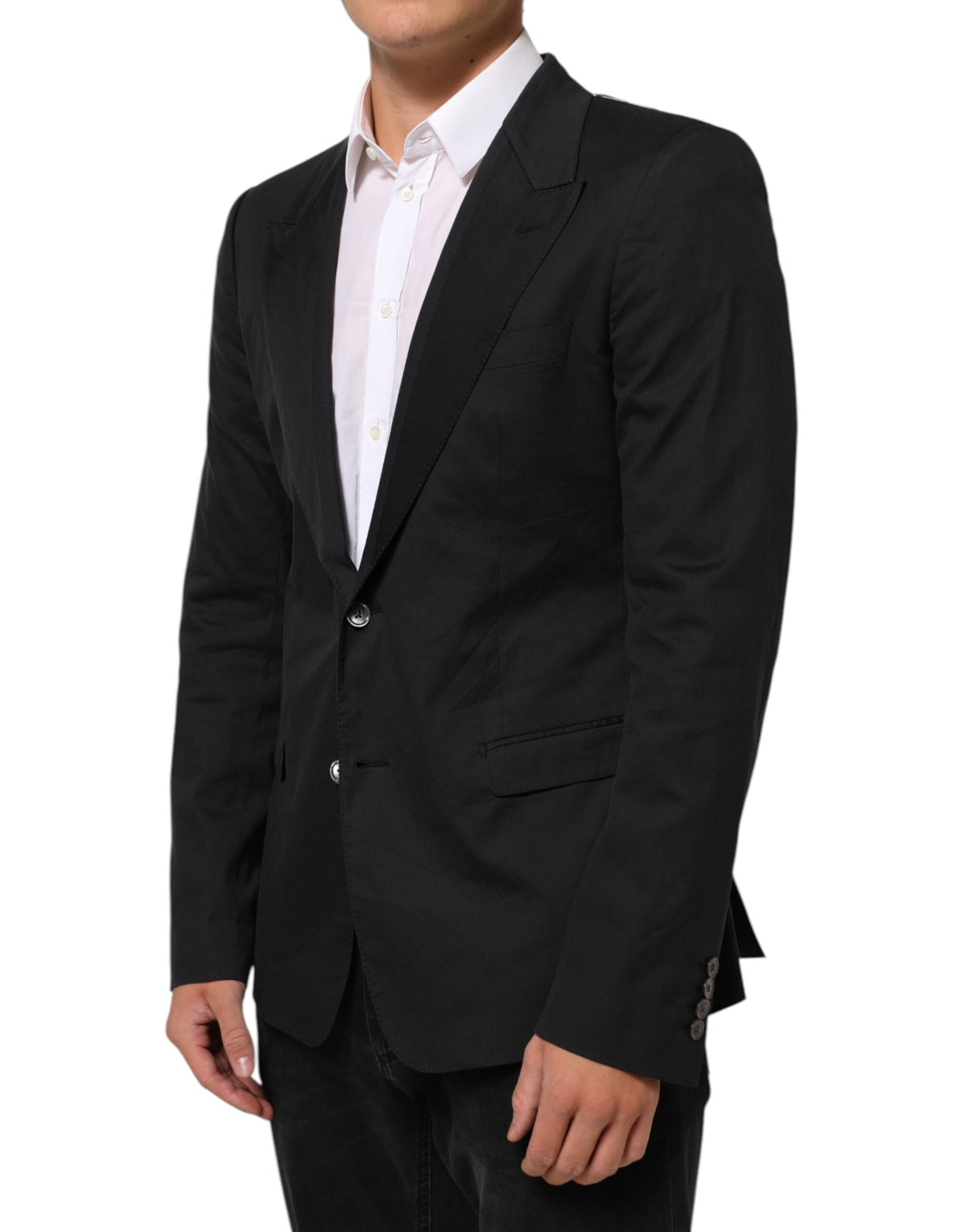 Elevate your wardrobe with the Dolce & Gabbana Black Cotton 2 Buttons Suit Jacket, a timeless blend of exquisite craftsmanship and luxurious materials, perfect for any occasion.