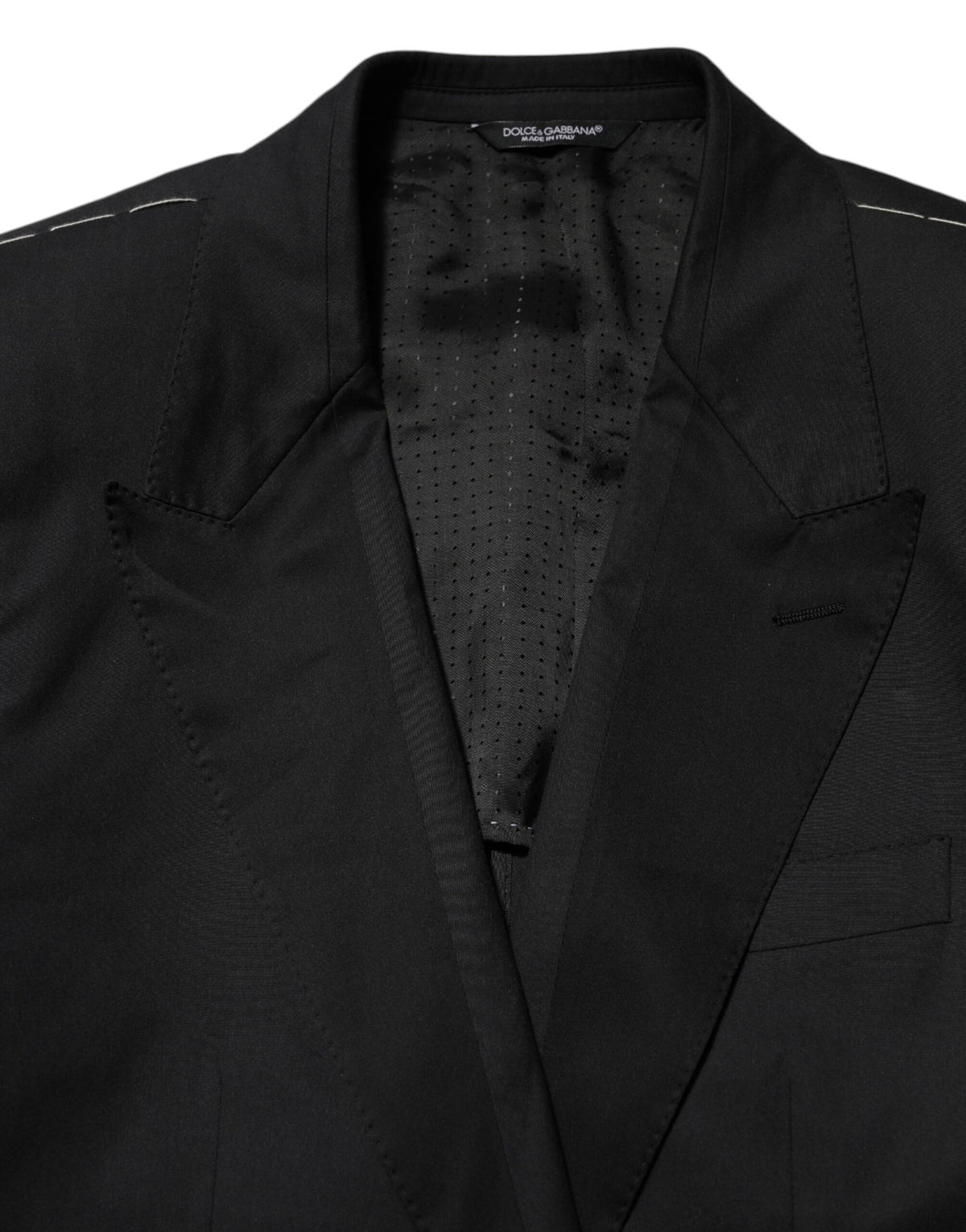 Experience the allure of Dolce & Gabbana's Black Cotton 2 Buttons Suit Jacket, a masterpiece of Italian craftsmanship that elevates your style with timeless elegance and luxurious comfort.