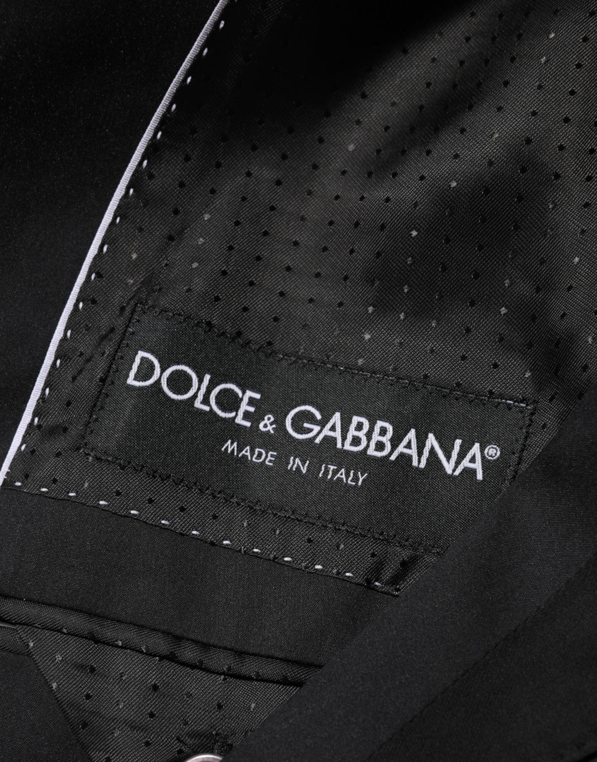 Elevate your wardrobe with the Dolce & Gabbana Black Cotton 2 Buttons Suit Jacket, a masterpiece of Italian craftsmanship that embodies timeless elegance and sophistication.