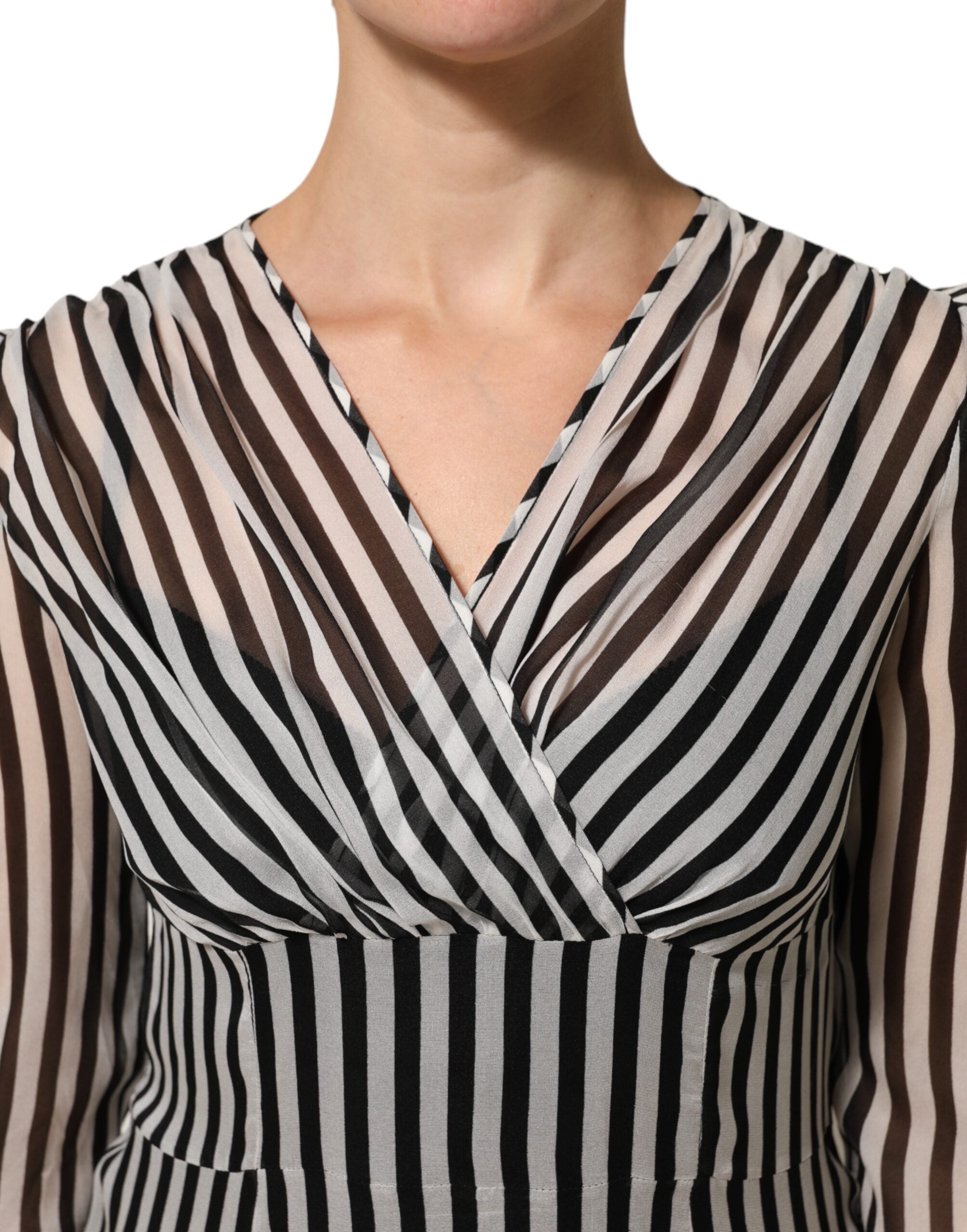 Experience the allure of Dolce & Gabbana's Black White Stripes Silk V-neck Midi Dress, a timeless piece that embodies luxury and sophistication for the discerning individual.