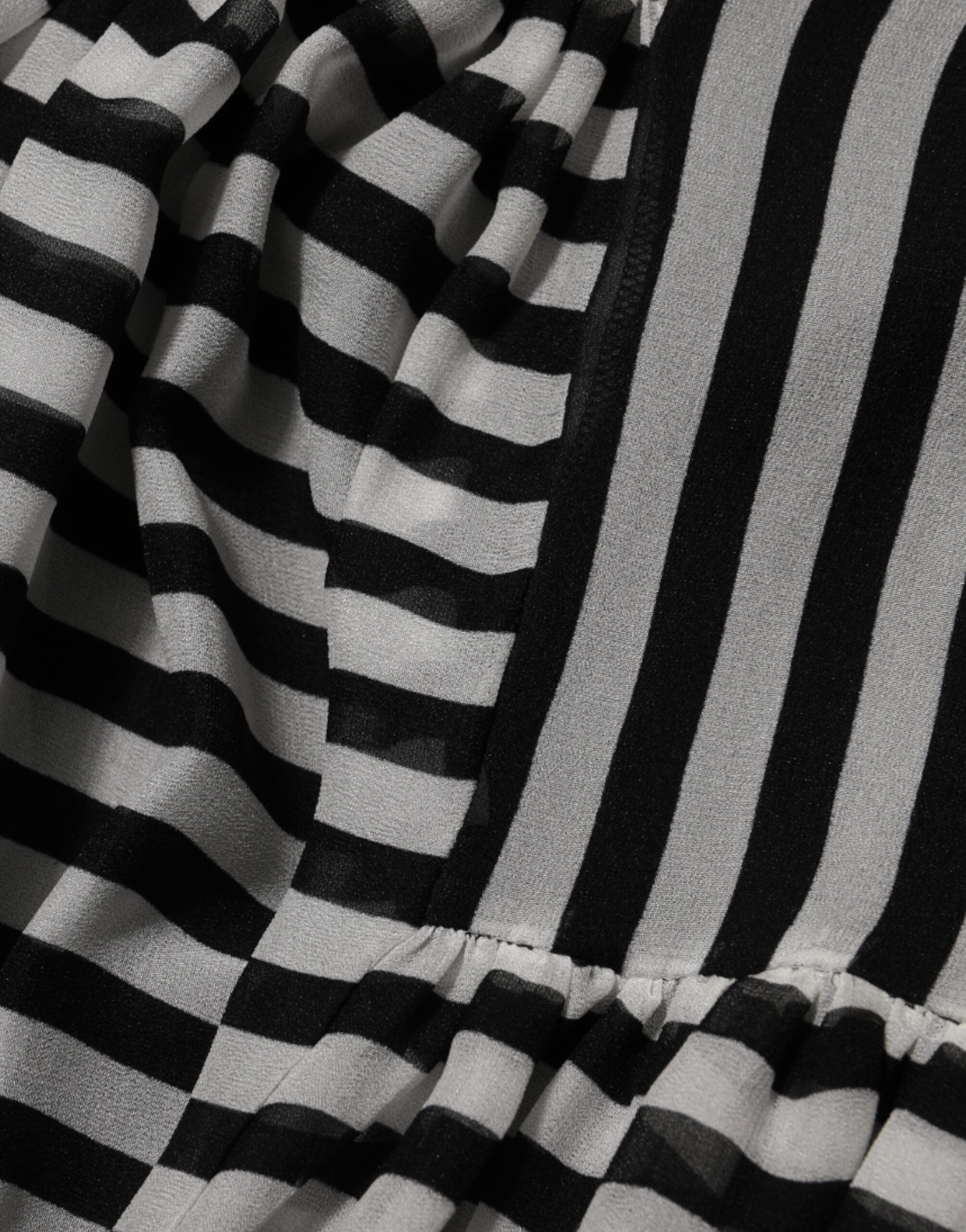 Experience the allure of the Dolce & Gabbana Black White Stripes Silk V-neck Midi Dress, where exquisite craftsmanship meets timeless elegance, perfect for sophisticated occasions.