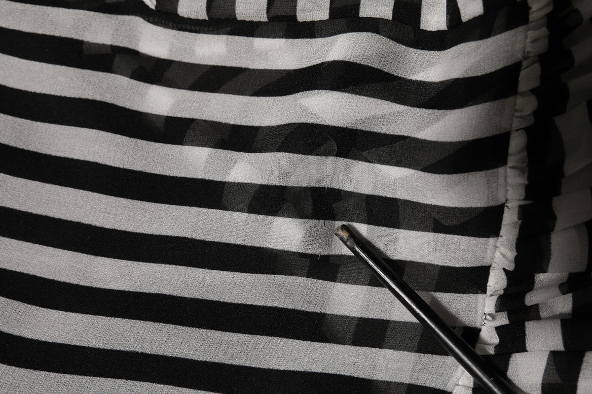 Experience the allure of Dolce & Gabbana's Black White Stripes Silk V-neck Midi Dress, a timeless piece that embodies luxury, sophistication, and exquisite Italian craftsmanship.