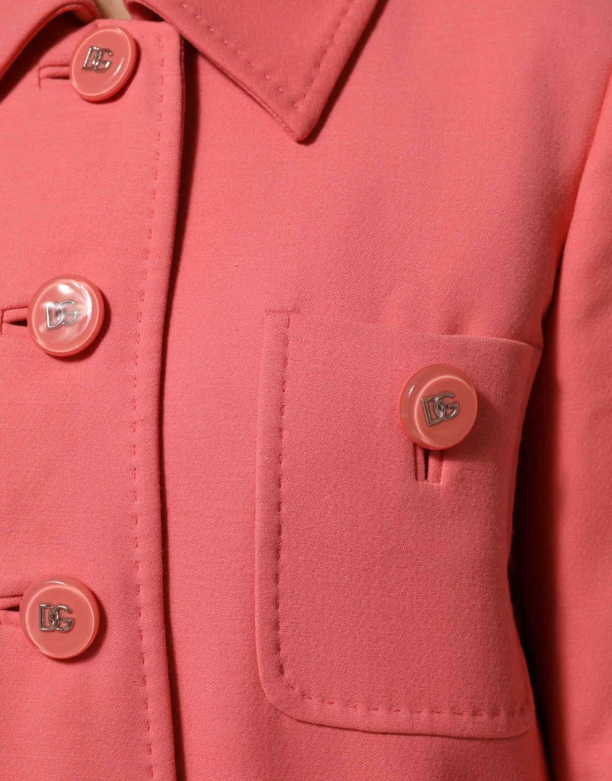 Experience the allure of the Dolce & Gabbana Pink Buttoned Down Trench Coat, a masterpiece of Italian craftsmanship in a sumptuous wool blend, redefining elegance for the discerning individual.
