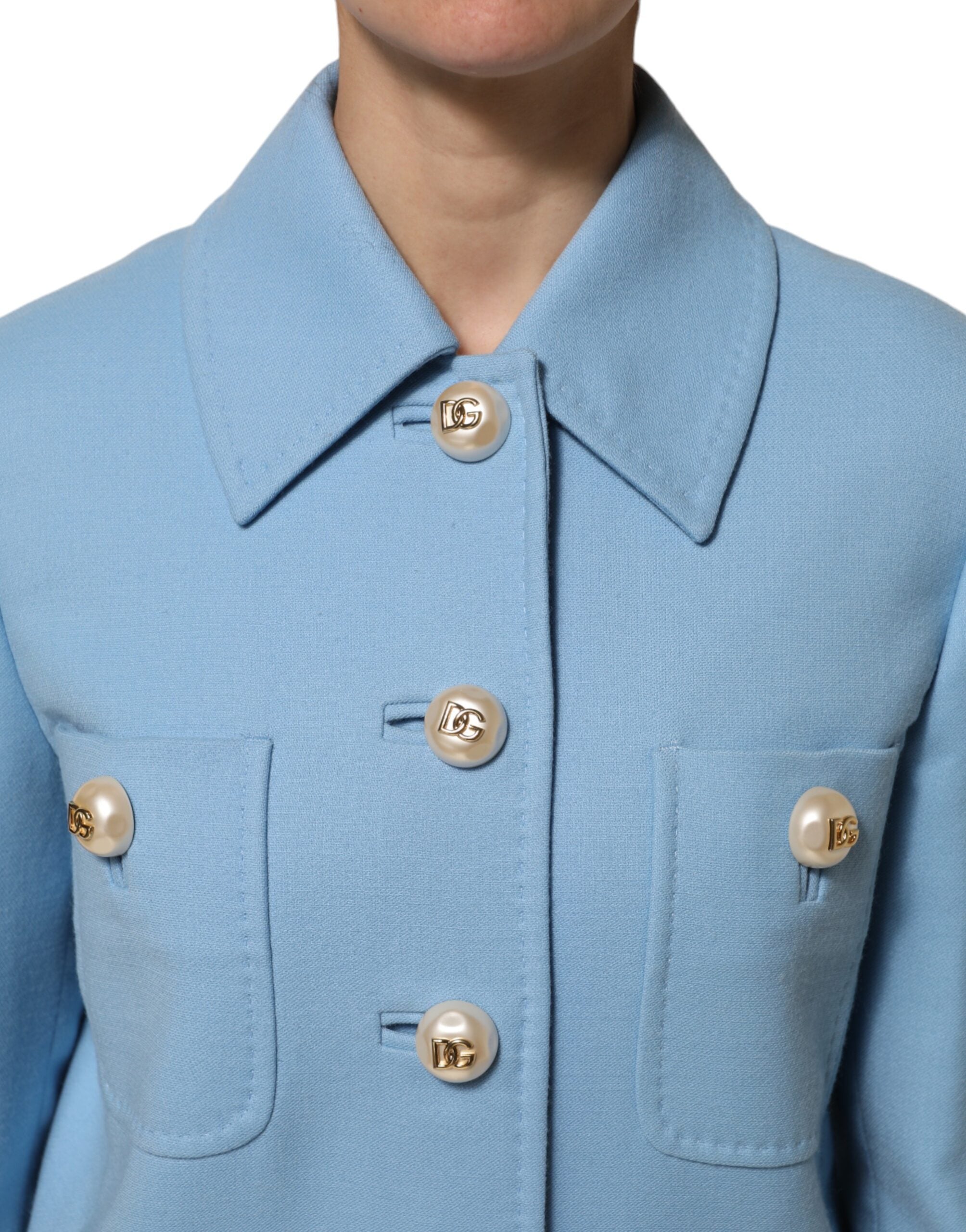 Discover the Dolce & Gabbana Blue Buttoned Down Trench Coat, a masterpiece of Italian craftsmanship in luxurious wool, embodying timeless elegance and sophistication.