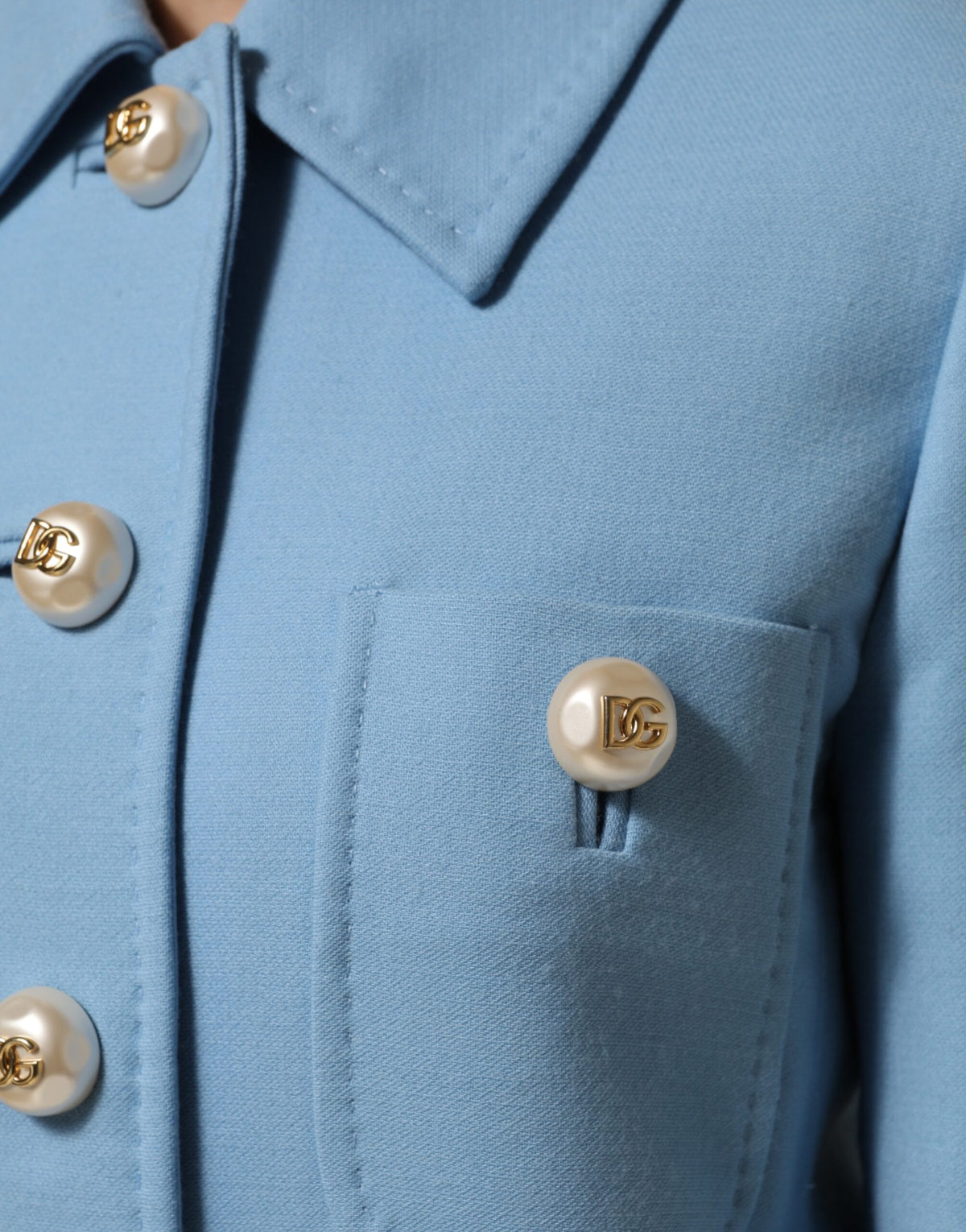 Elevate your wardrobe with the Dolce & Gabbana Blue Buttoned Down Trench Coat, a luxurious wool masterpiece that embodies timeless elegance and Italian craftsmanship.