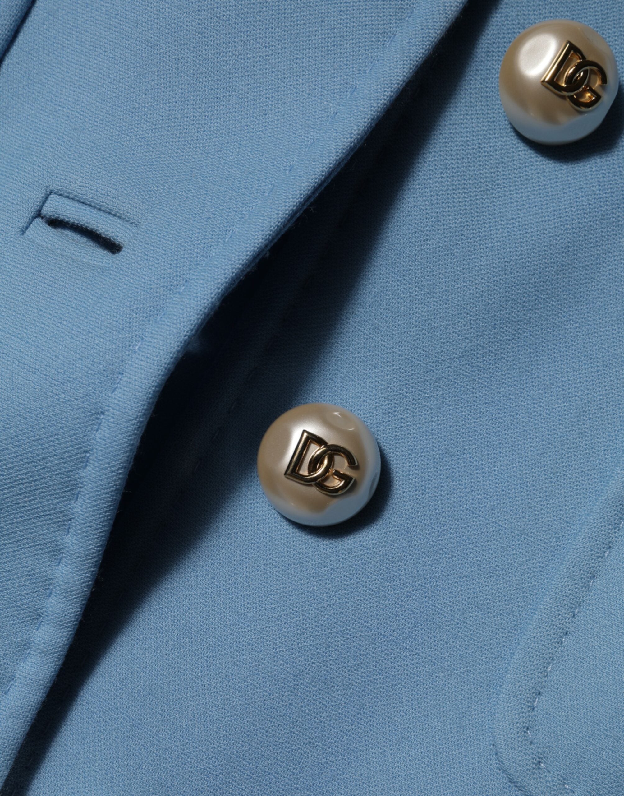 Elevate your wardrobe with the Dolce & Gabbana Blue Buttoned Down Trench Coat, a luxurious 100% wool masterpiece that embodies timeless elegance and Italian craftsmanship.
