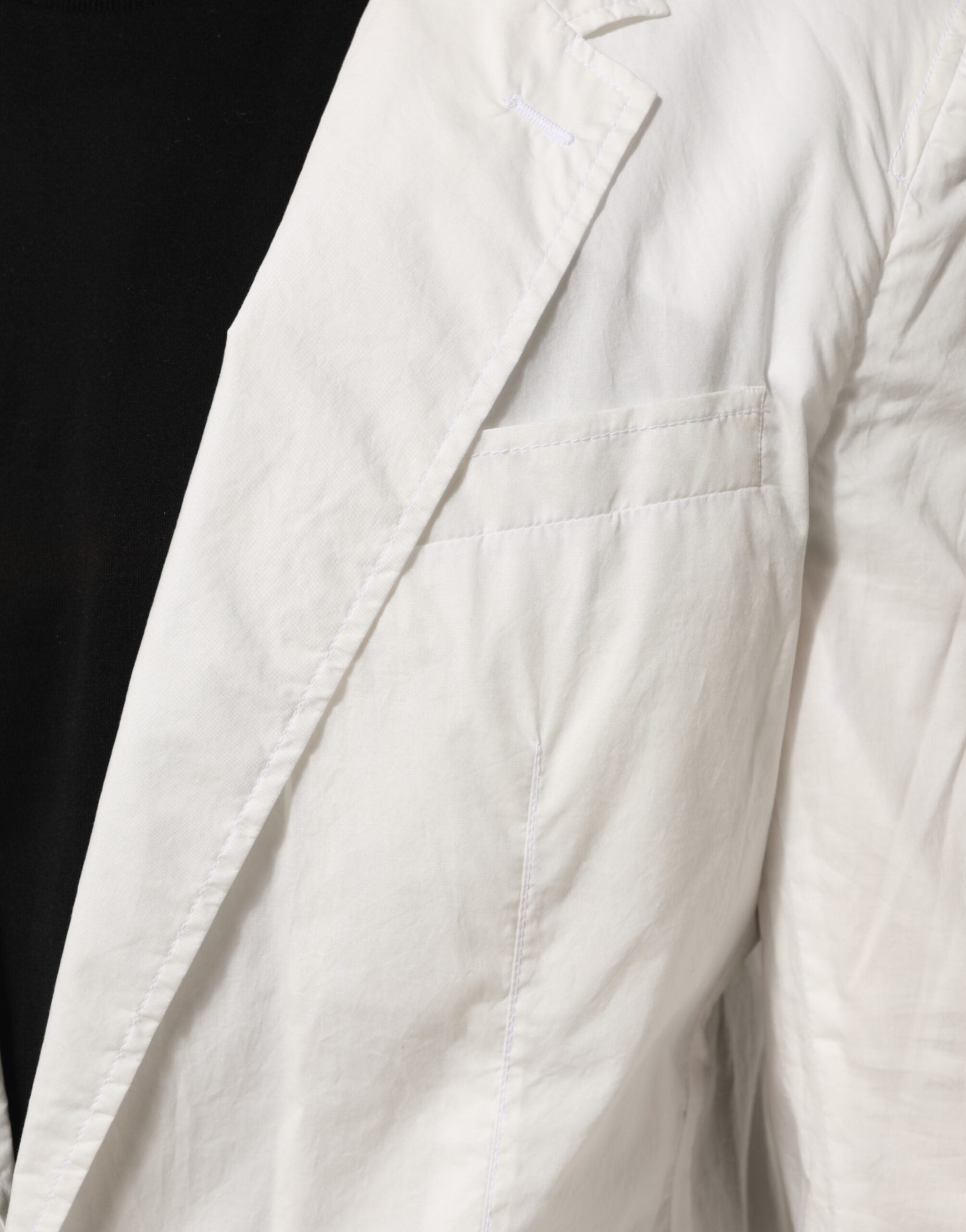 Elevate your summer wardrobe with the Dolce & Gabbana White Cotton 1 Button Men Suit Blazer, a masterpiece of Italian craftsmanship that embodies timeless sophistication and effortless elegance.