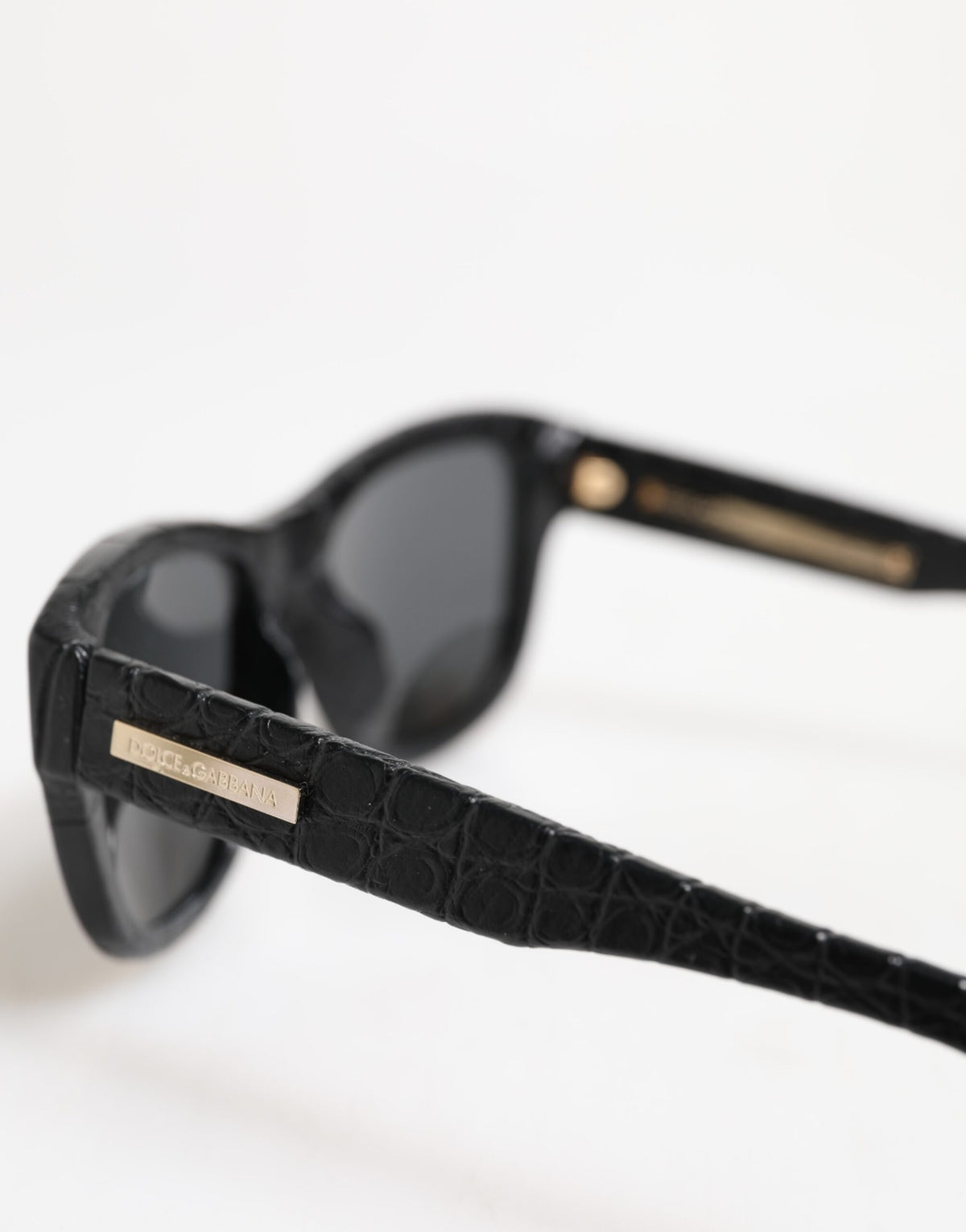 Indulge in the exquisite craftsmanship of Dolce & Gabbana DG4177 sunglasses, where luxurious alligator leather meets timeless elegance, perfect for the discerning individual.