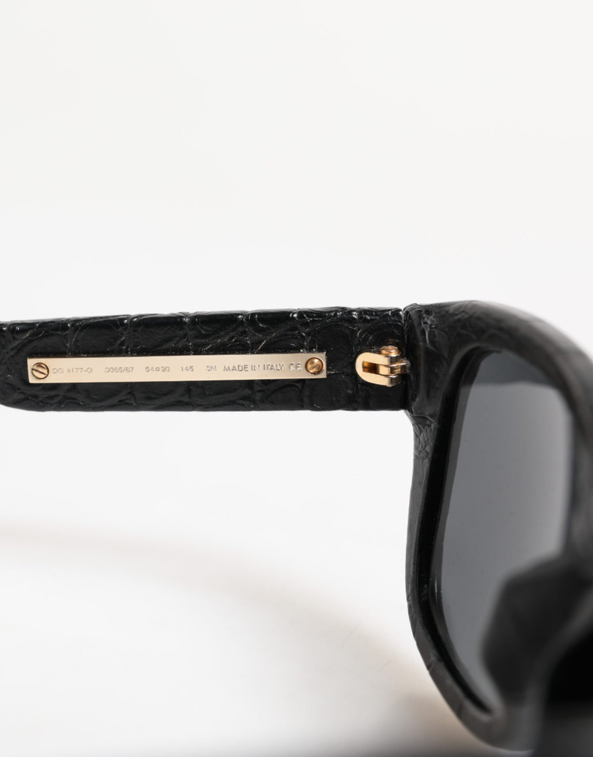 Indulge in the exquisite Dolce & Gabbana DG4177 sunglasses, crafted from luxurious alligator leather, embodying timeless elegance and confident allure for the discerning individual.