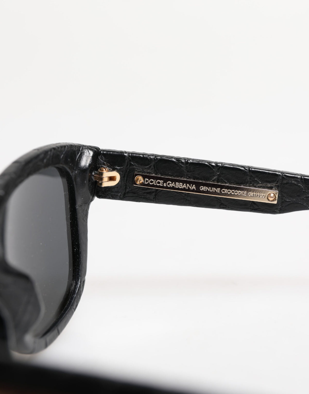 Indulge in the exquisite allure of Dolce & Gabbana DG4177 sunglasses, crafted from luxurious alligator leather, embodying timeless elegance and confident sophistication.
