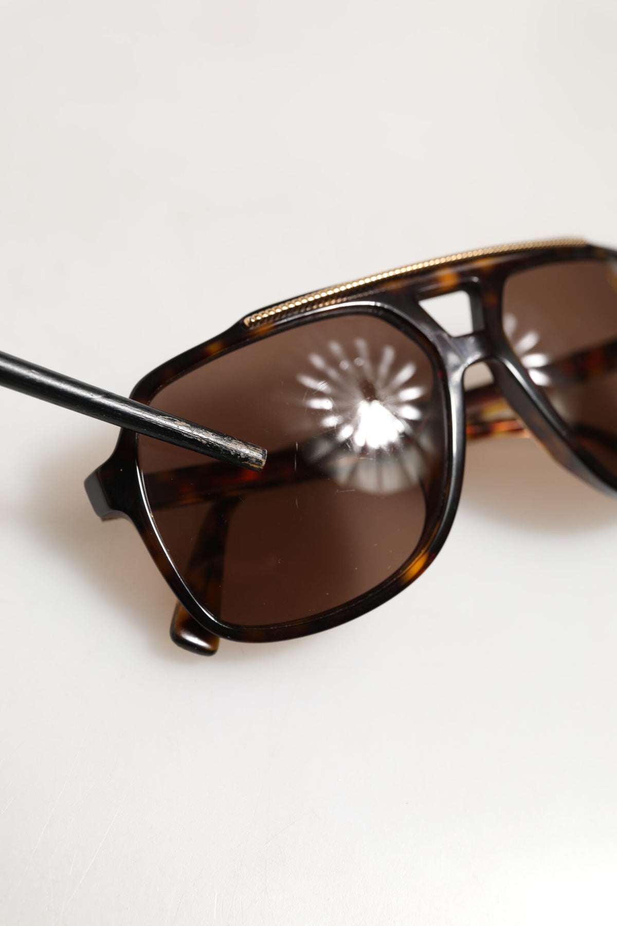 Experience the allure of Dolce & Gabbana's Dark Brown Tortoise Shell Pilot Frame Sunglasses, where exquisite craftsmanship meets timeless elegance, perfect for the discerning individual.